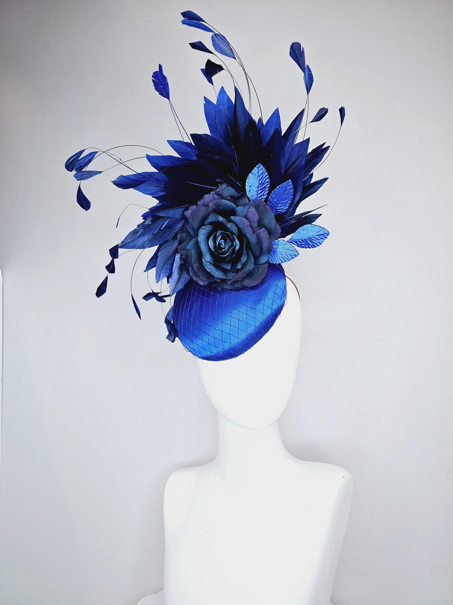 kentucky derby hat fascinator royal blue satin with netting,navy blue rose flower,cobalt blue leaves,navy royal blue branching feathers