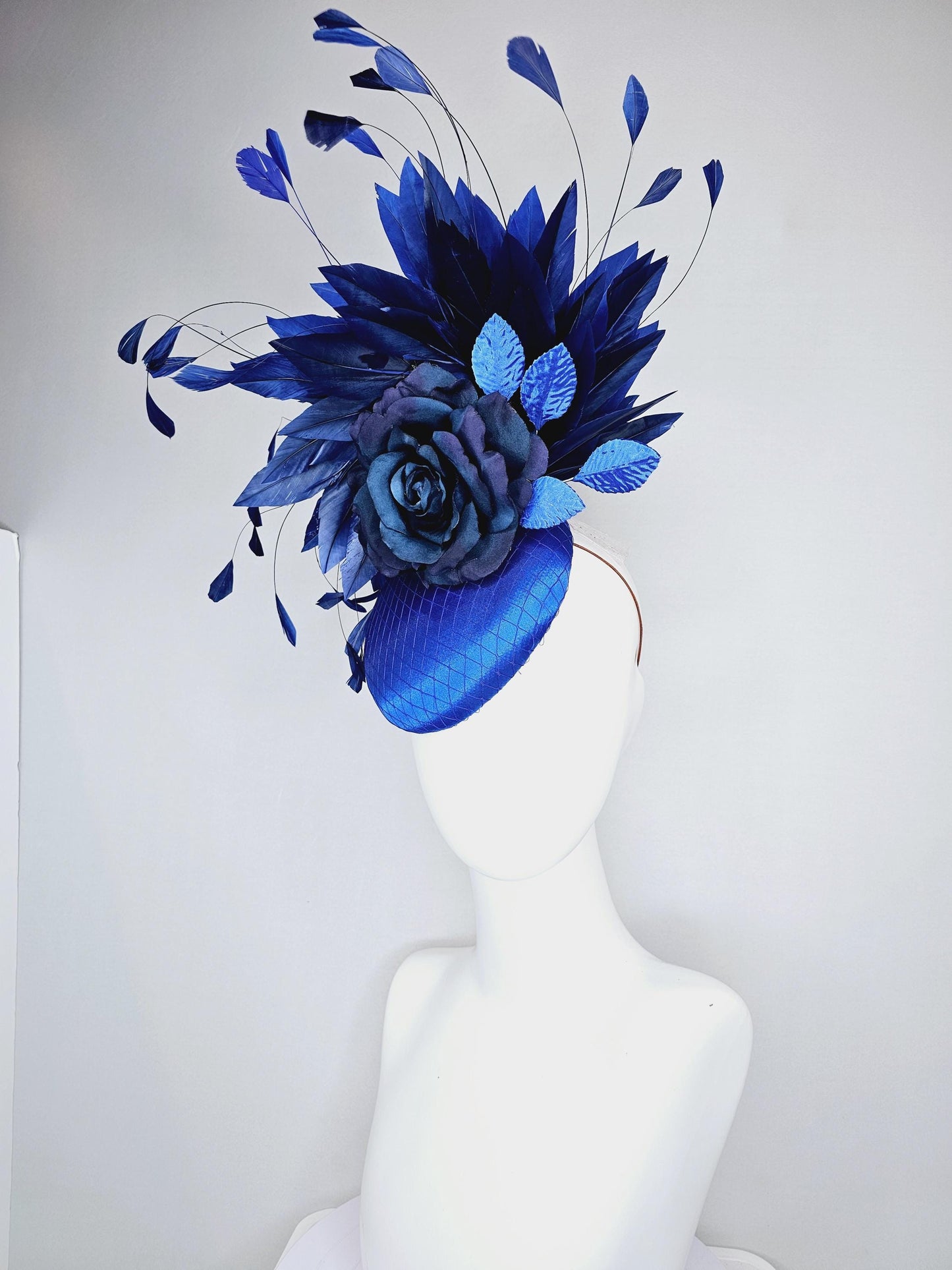 kentucky derby hat fascinator royal blue satin with netting,navy blue rose flower,cobalt blue leaves,navy royal blue branching feathers