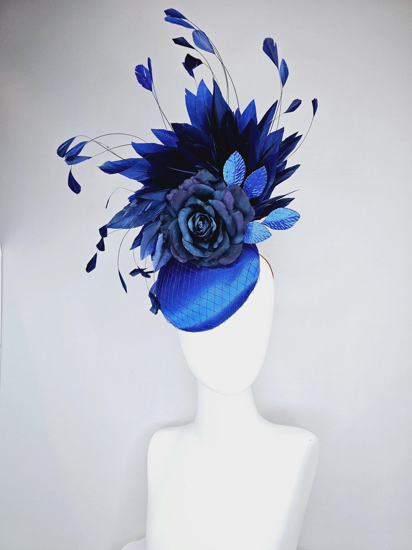 kentucky derby hat fascinator royal blue satin with netting,navy blue rose flower,cobalt blue leaves,navy royal blue branching feathers