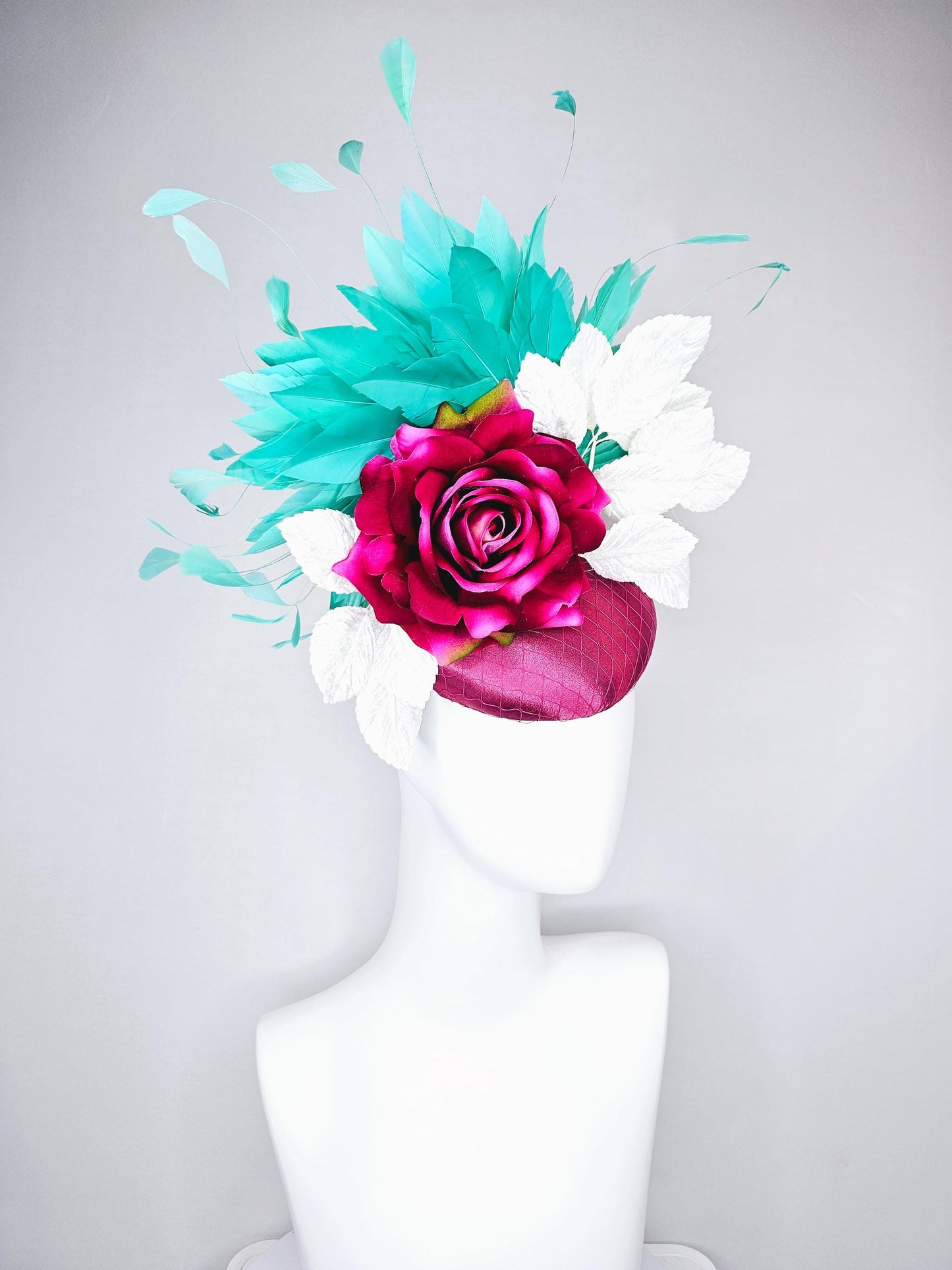 kentucky derby hat fascinator hot pink satin with netting,hot pink fuchsia satin silk rose flower,white leaves,aqua blue branching feathers