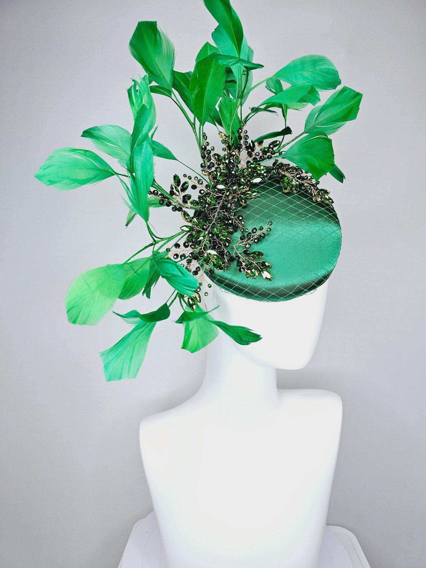 kentucky derby hat fascinator emerald green satin with netting and green crystal beaded jewels stems, emerald green branching feathers