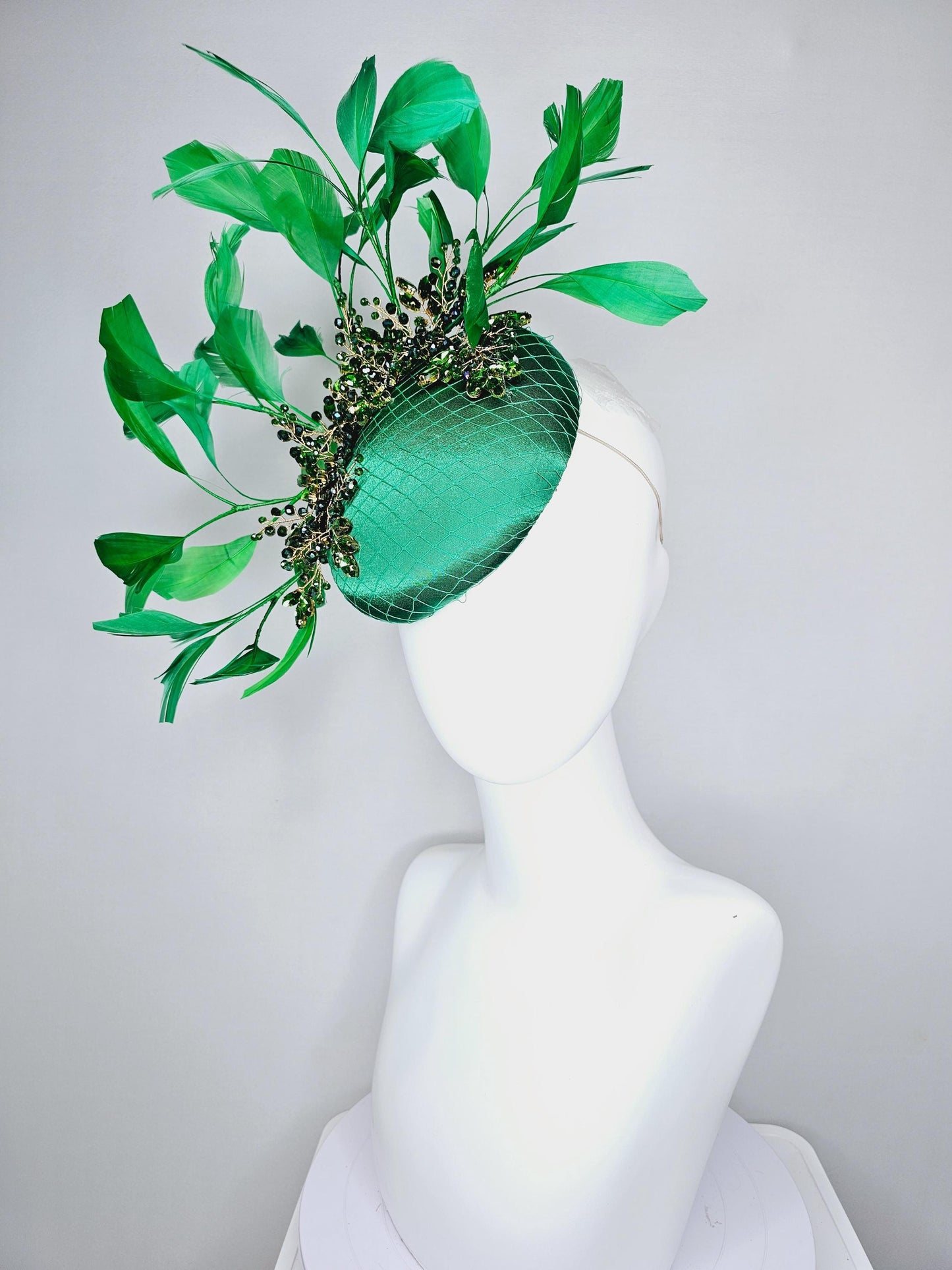 kentucky derby hat fascinator emerald green satin with netting and green crystal beaded jewels stems, emerald green branching feathers