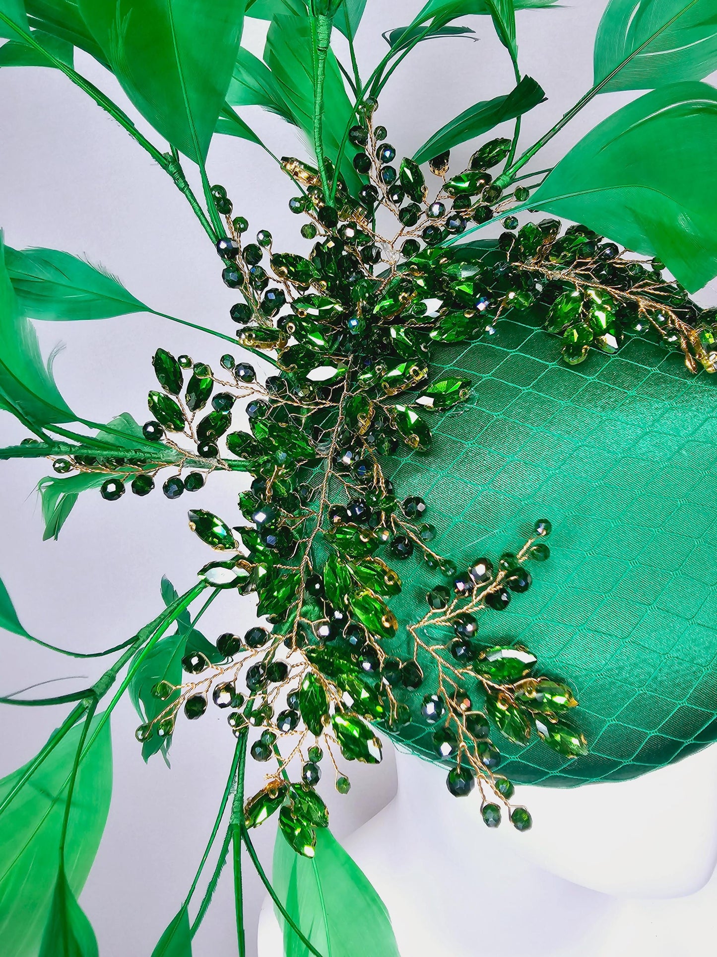 kentucky derby hat fascinator emerald green satin with netting and green crystal beaded jewels stems, emerald green branching feathers