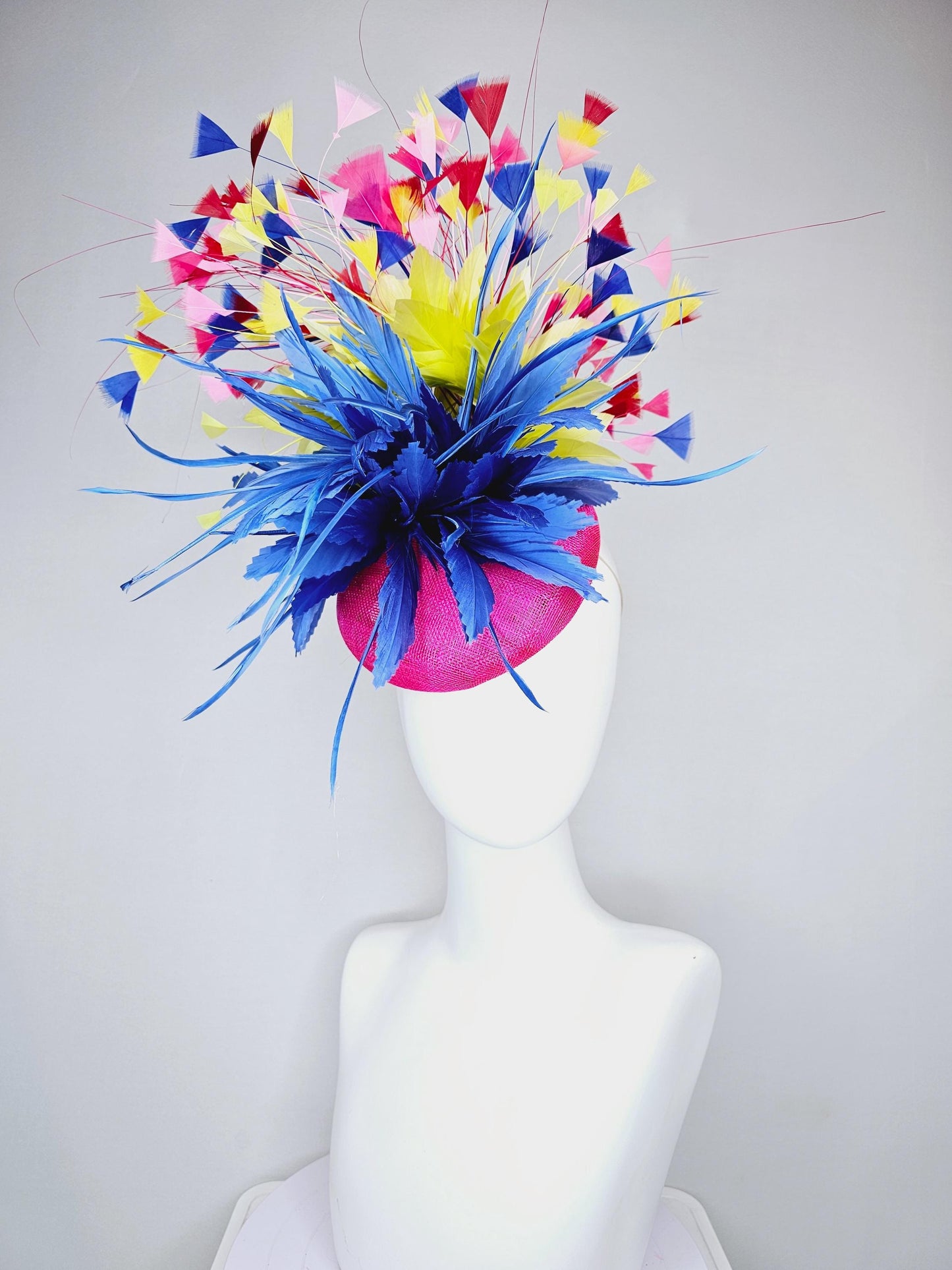 kentucky derby hat fascinator hot pink sinamay with large royal blue feather flower,branching colorful rainbow yellow,blue,red,pink feathers