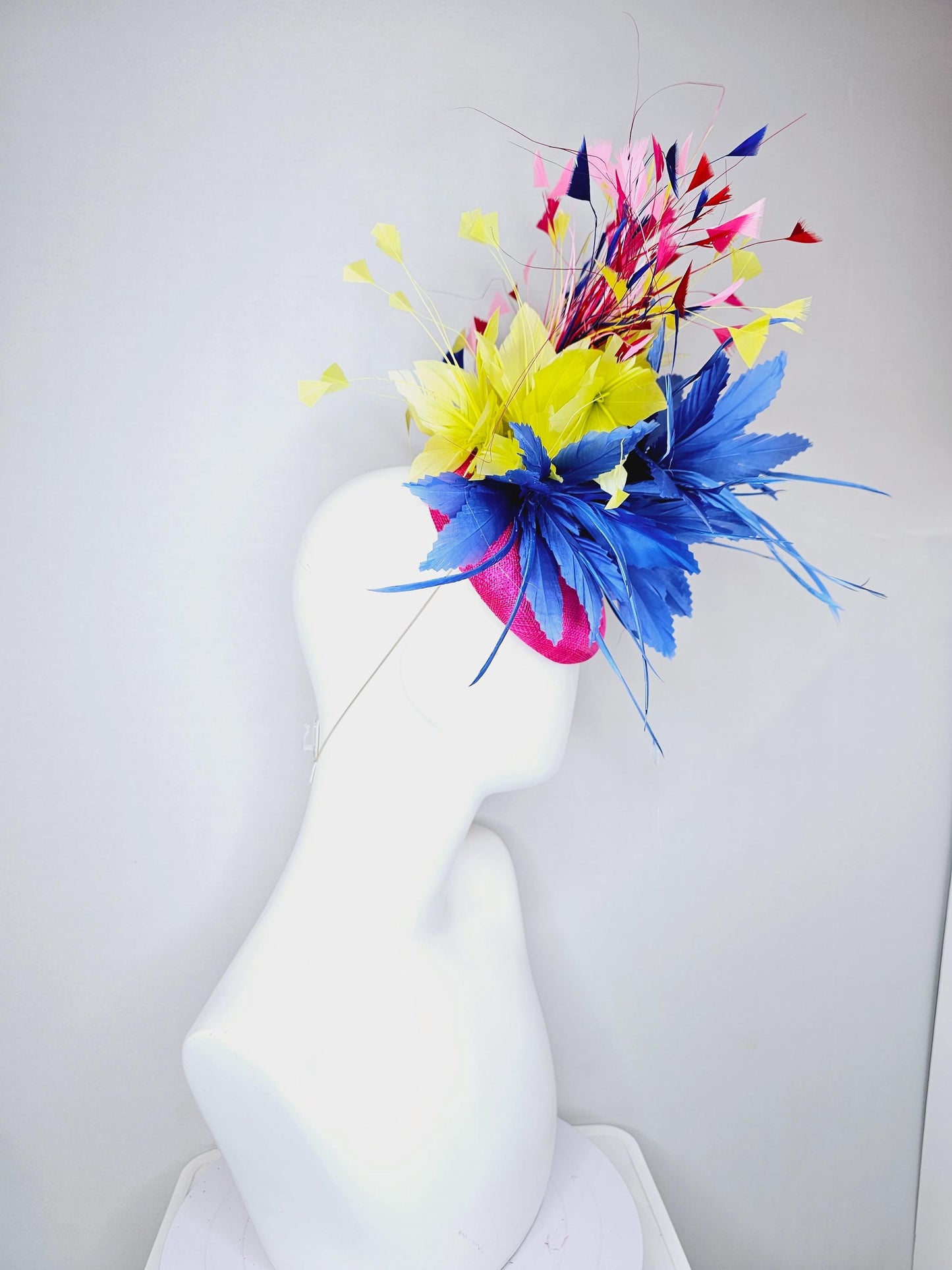 kentucky derby hat fascinator hot pink sinamay with large royal blue feather flower,branching colorful rainbow yellow,blue,red,pink feathers