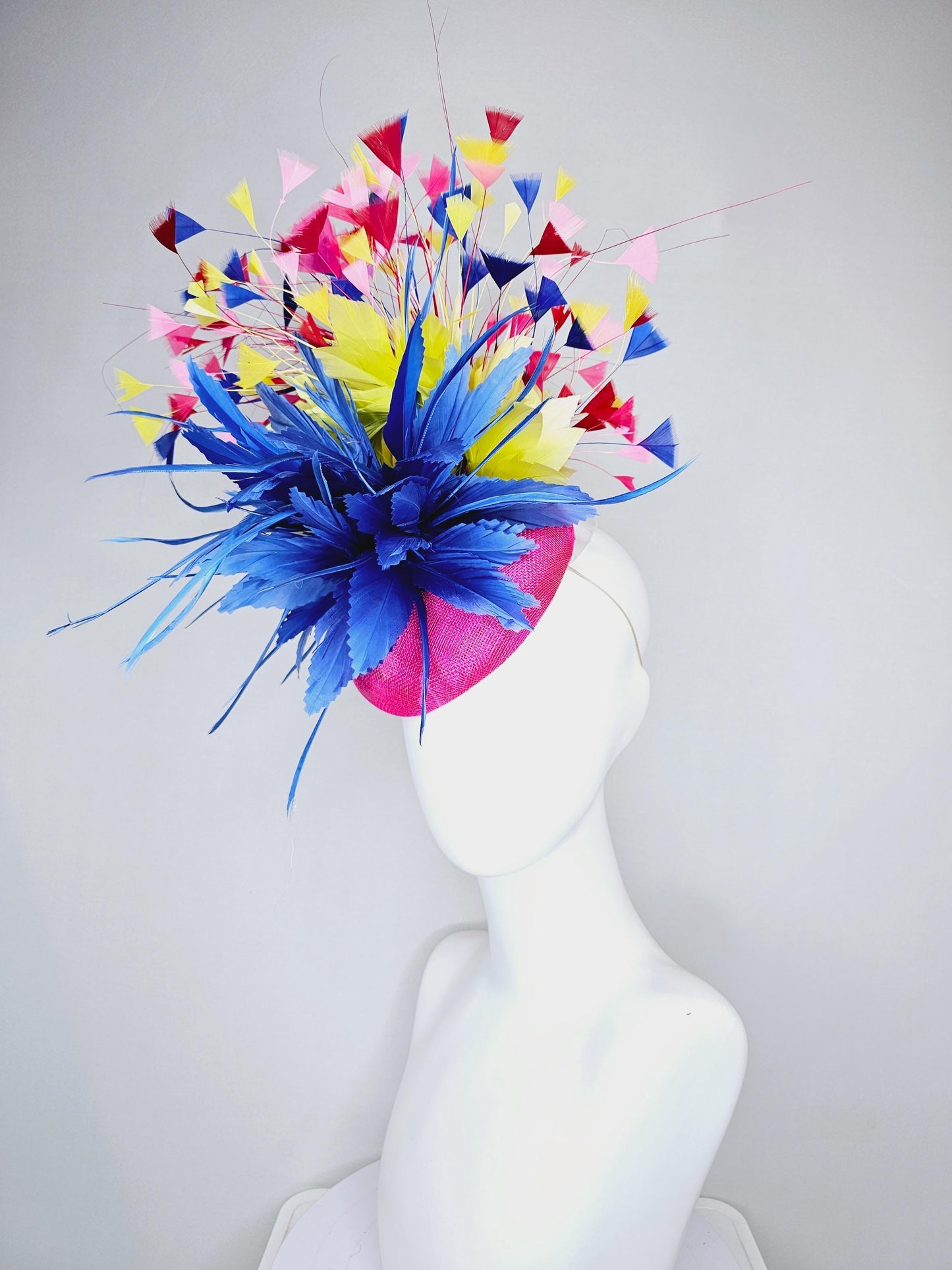 kentucky derby hat fascinator hot pink sinamay with large royal blue feather flower,branching colorful rainbow yellow,blue,red,pink feathers