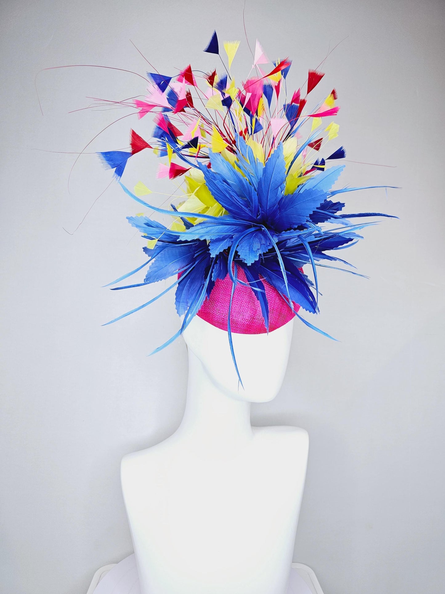 kentucky derby hat fascinator hot pink sinamay with large royal blue feather flower,branching colorful rainbow yellow,blue,red,pink feathers