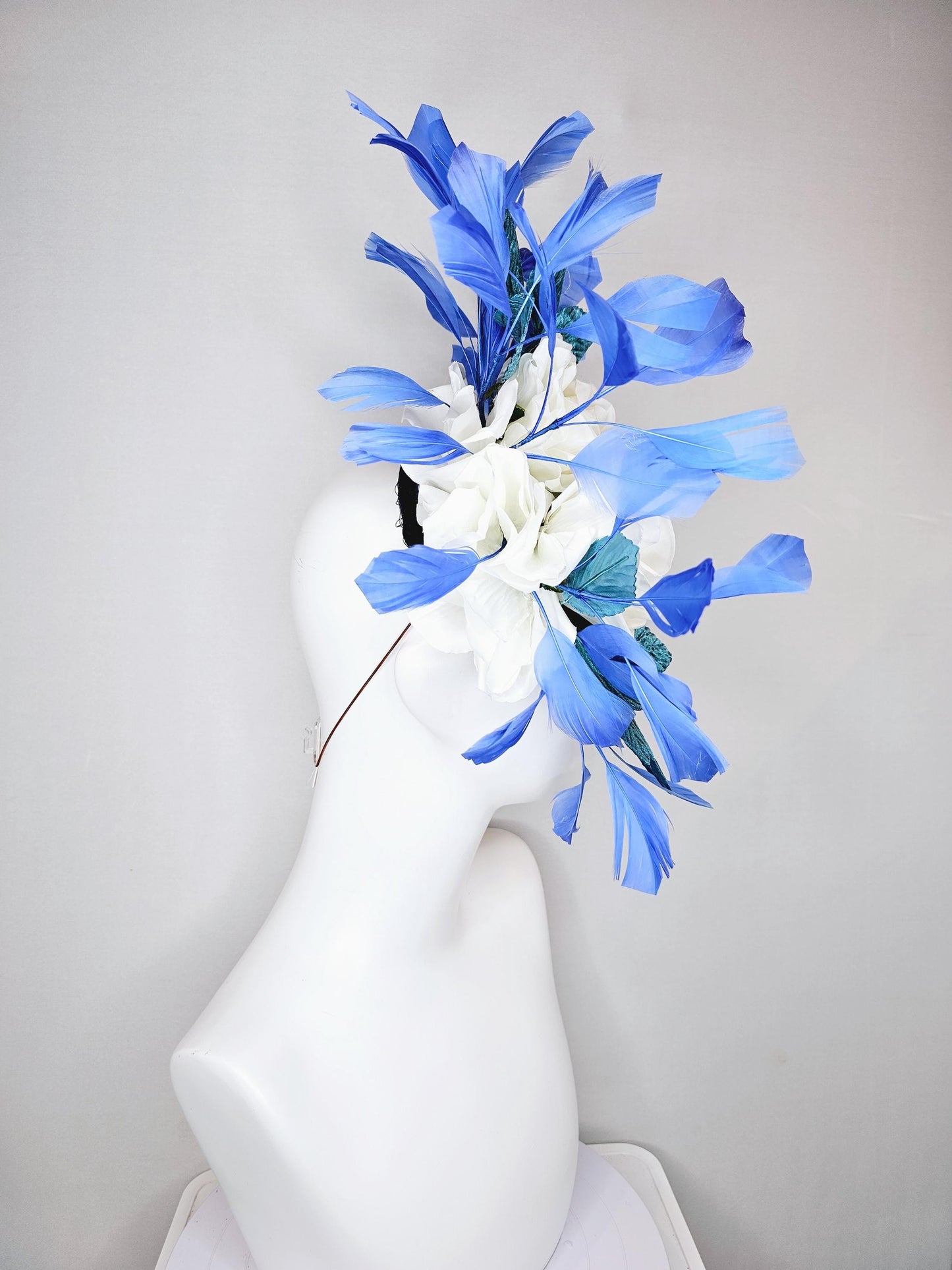 kentucky derby hat fascinator midnight navy blue satin with white silk flowers,teal blue velvet leaves,and royal blue branching feathers