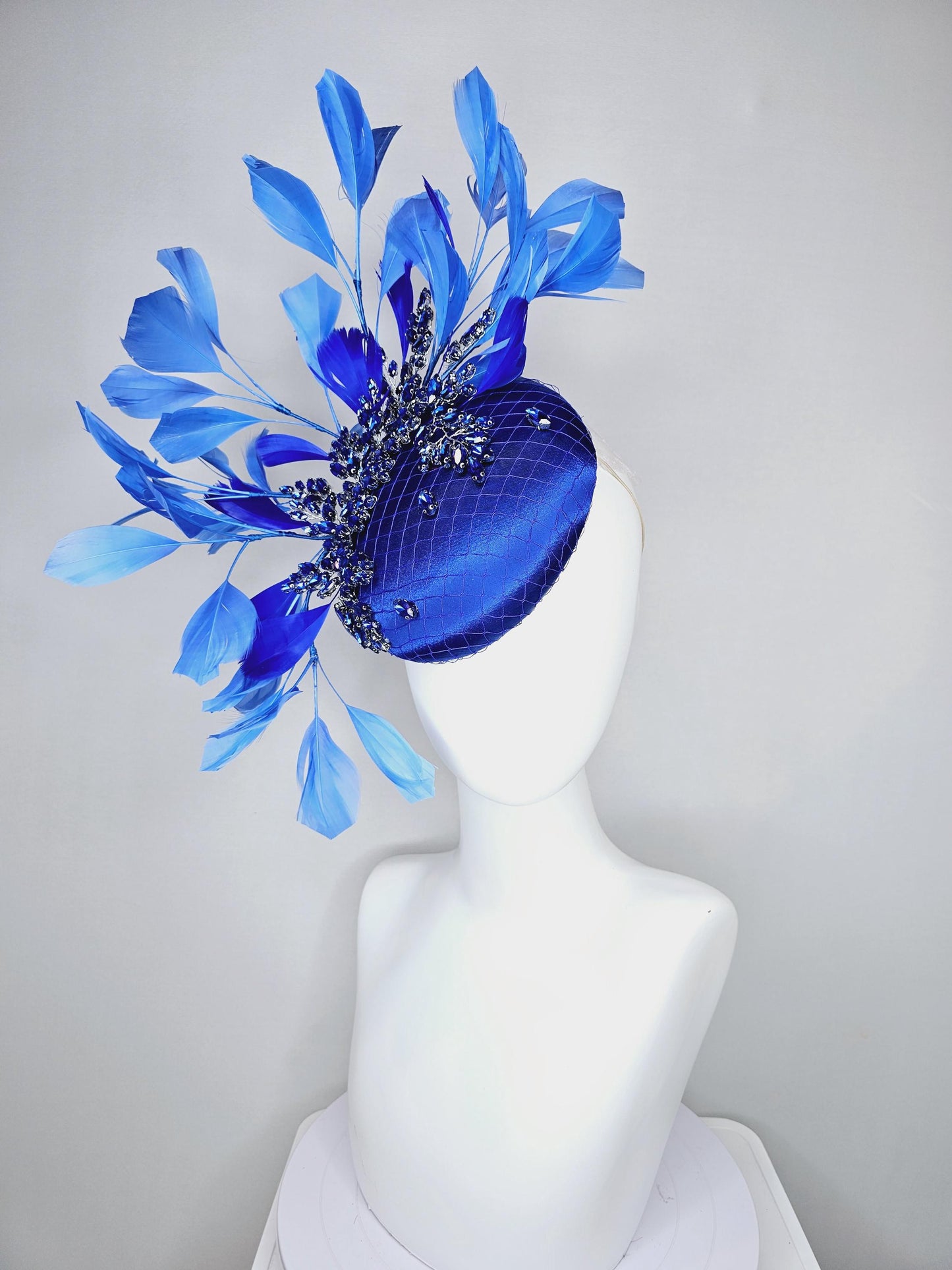 kentucky derby hat fascinator royal blue satin with netting and royal blue crystal beaded jewels stems, royal cobalt blue branching feathers