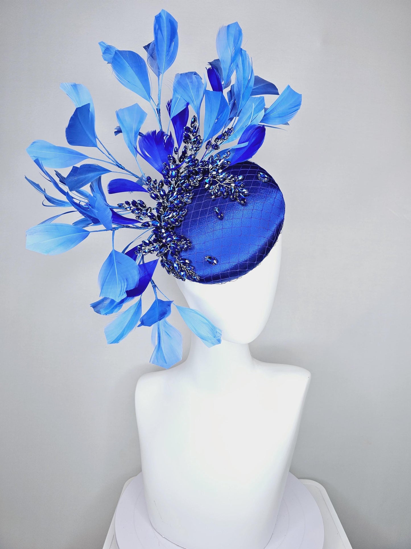 kentucky derby hat fascinator royal blue satin with netting and royal blue crystal beaded jewels stems, royal cobalt blue branching feathers