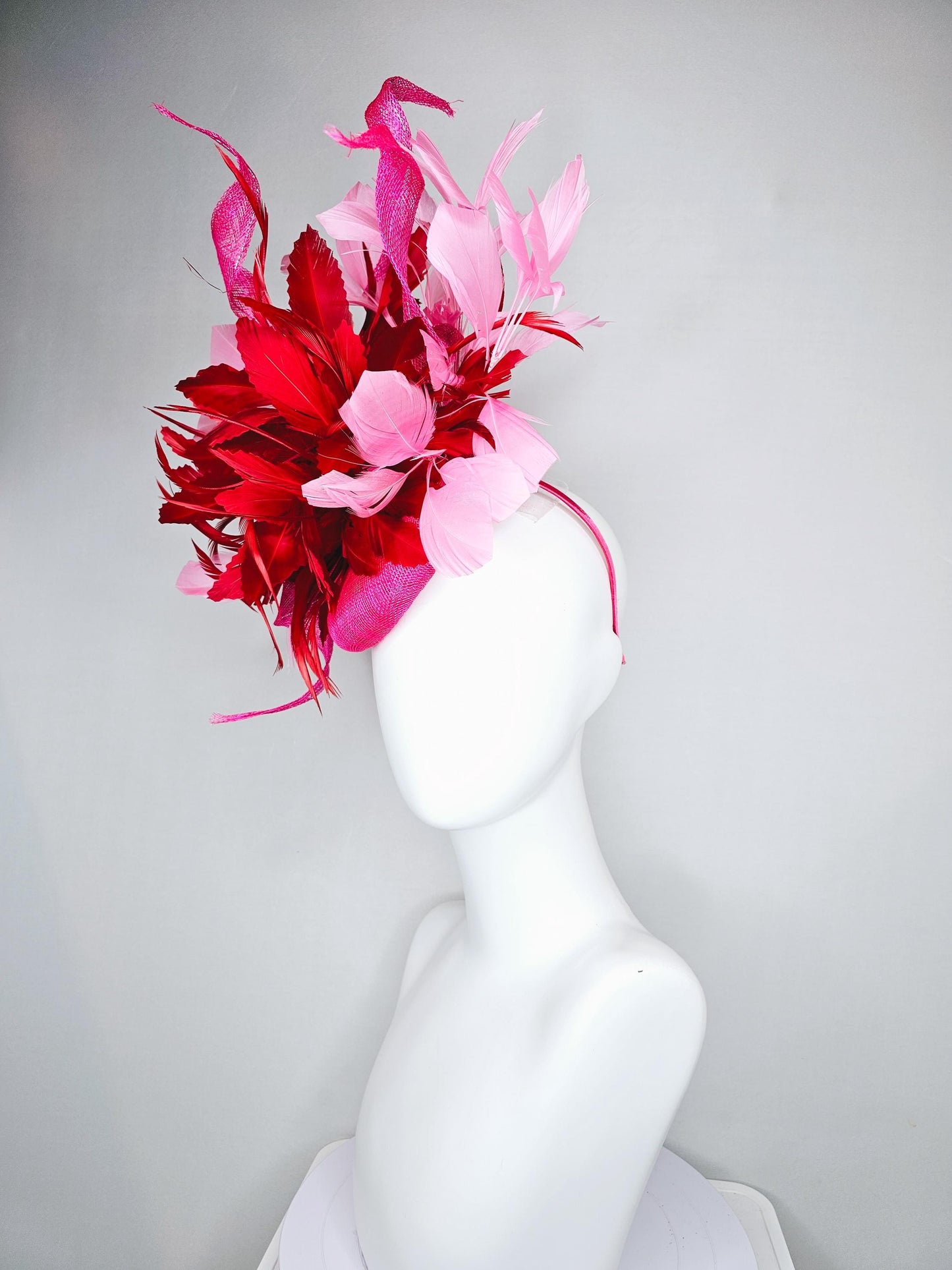 kentucky derby hat fascinator pink sinamay with large curls,bright red feathers and light pink branching feathers