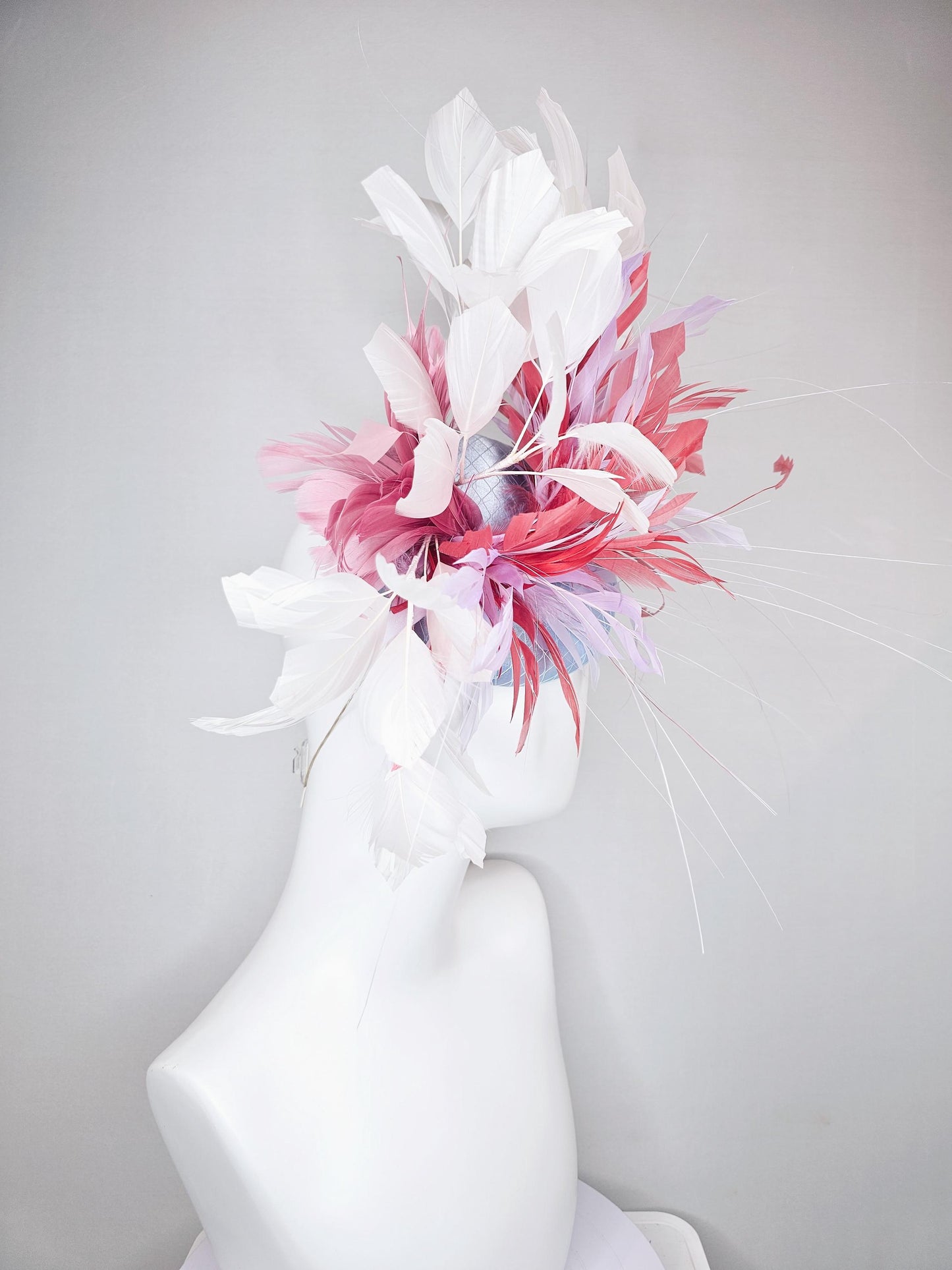 kentucky derby hat fascinator light baby blue satin with netting with blush pink,white,and light purple branching feathers