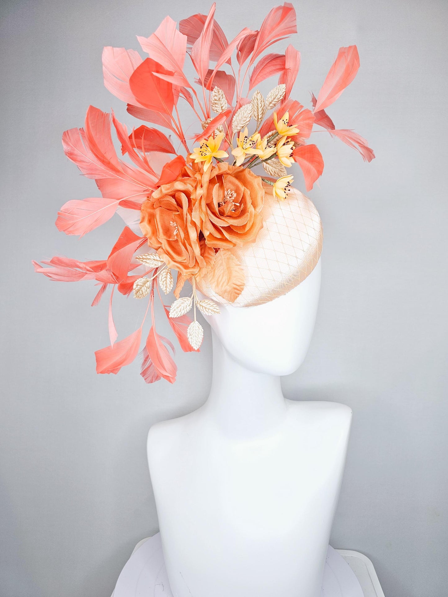 kentucky derby hat fascinator champagne satin with netting,orange satin flowers,yellow floral stems,coral orange feathers and gold leaves