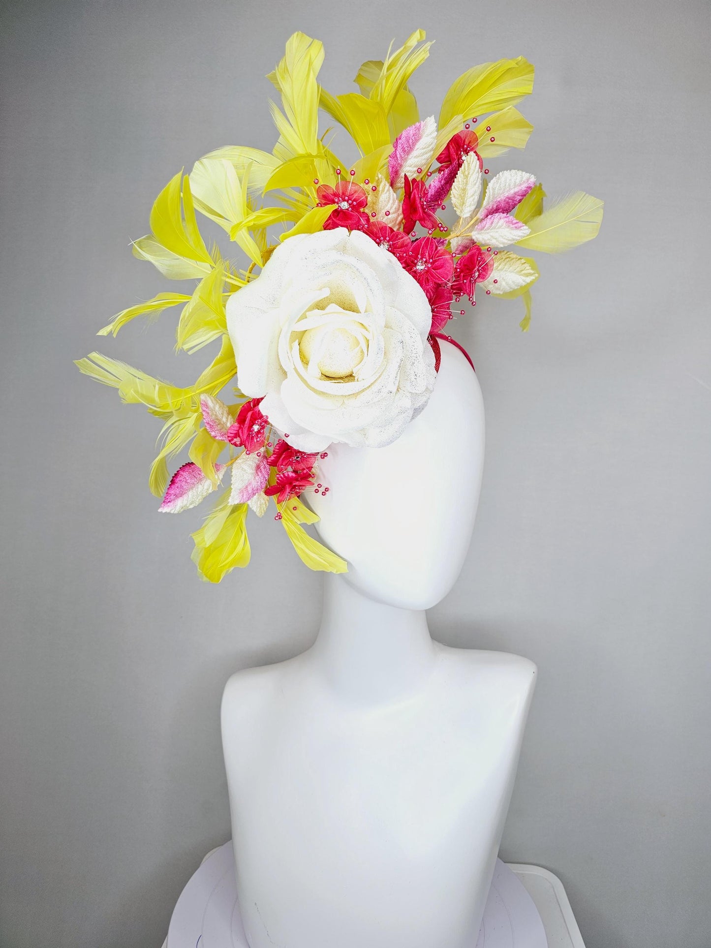 kentucky derby hat fascinator ivory white satin rose,hot pink satin flowers with pearls, yellow pink ombre leaves, yellow branching feathers