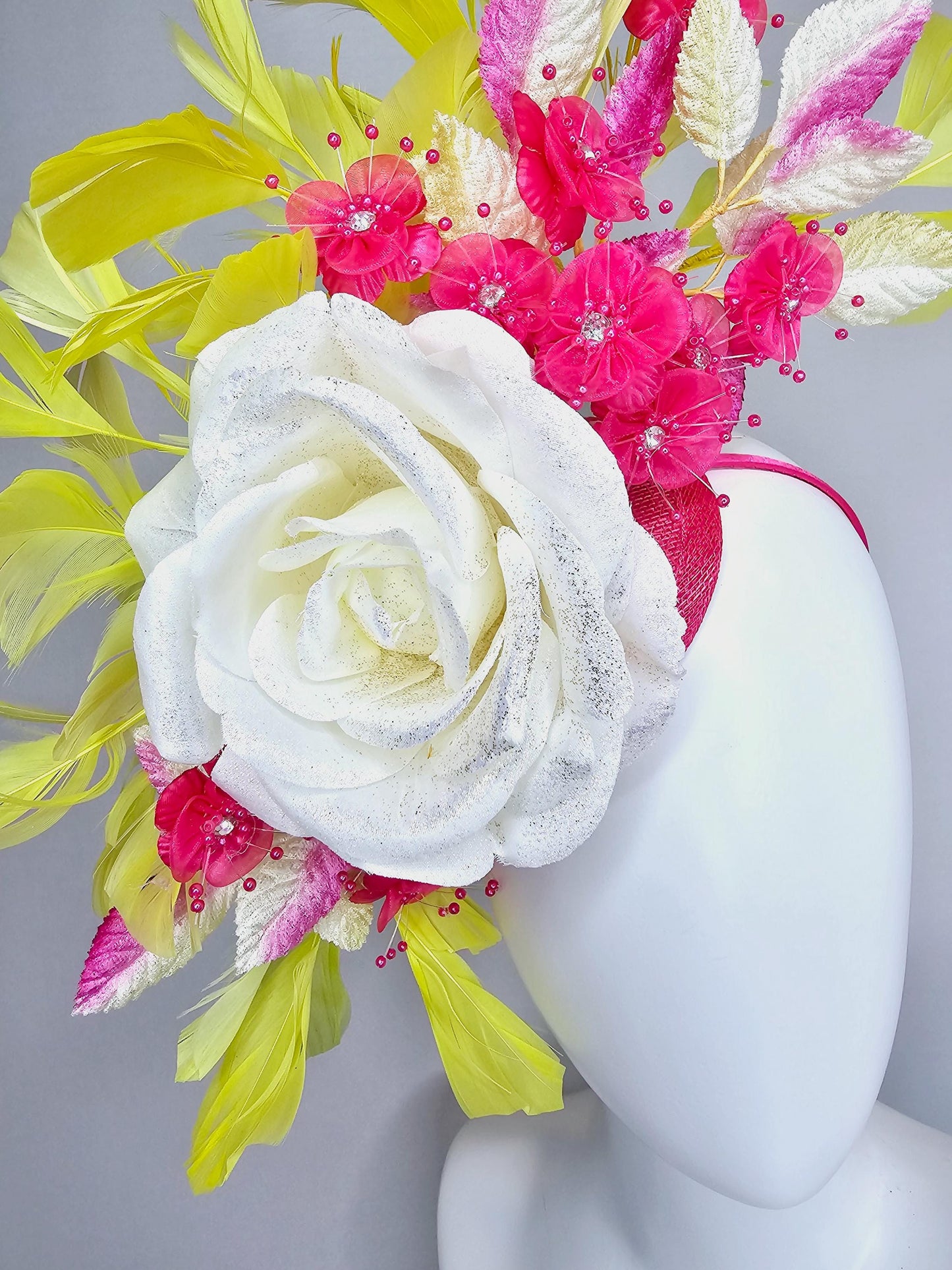 kentucky derby hat fascinator ivory white satin rose,hot pink satin flowers with pearls, yellow pink ombre leaves, yellow branching feathers