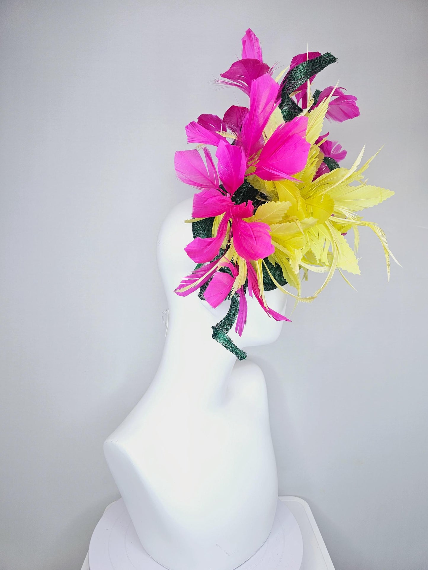 kentucky derby hat fascinator dark green sinamay with curls and fluffy yellow zigzag feather flower, bright pink fuchsia branching feathers