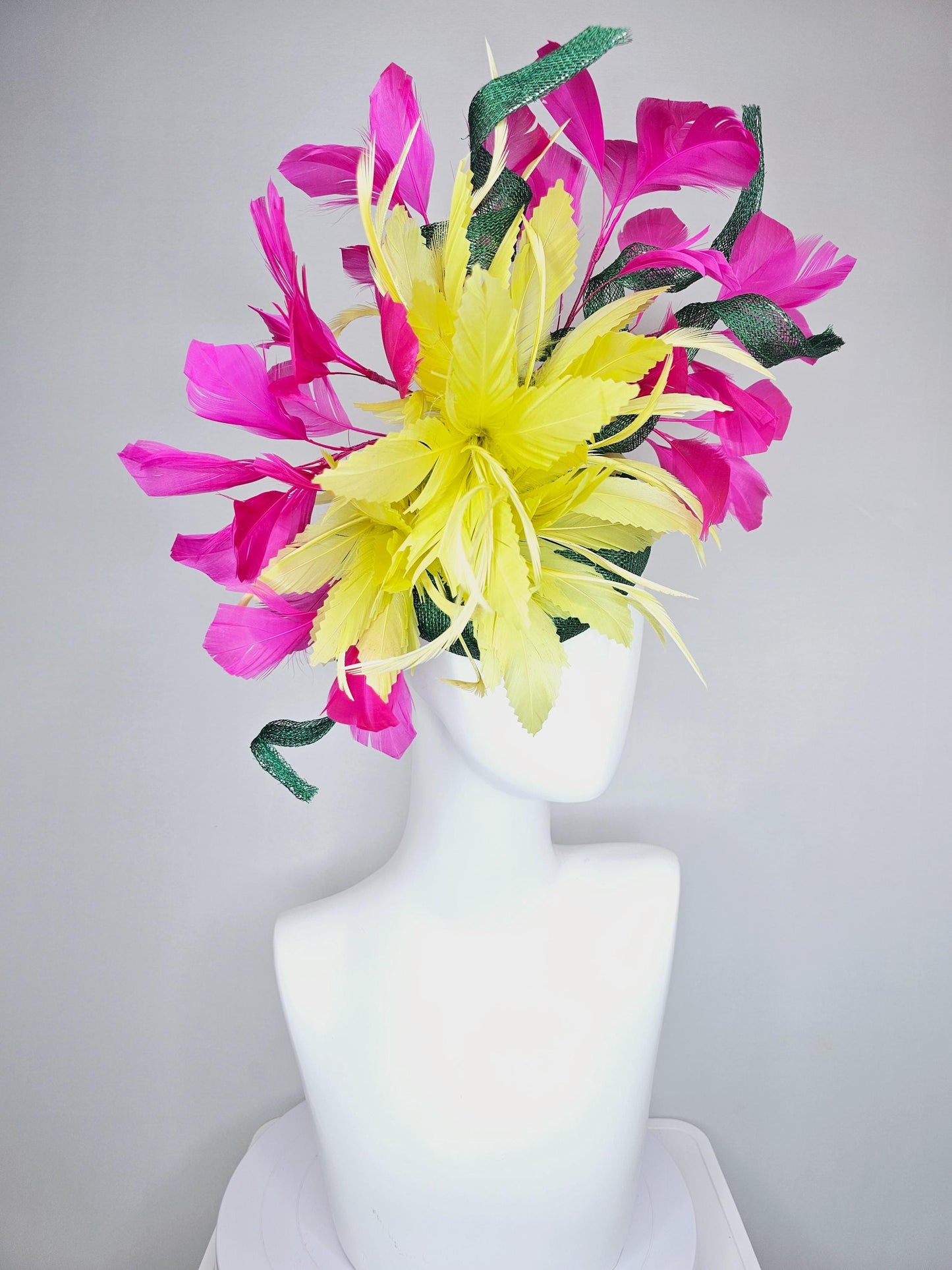 kentucky derby hat fascinator dark green sinamay with curls and fluffy yellow zigzag feather flower, bright pink fuchsia branching feathers