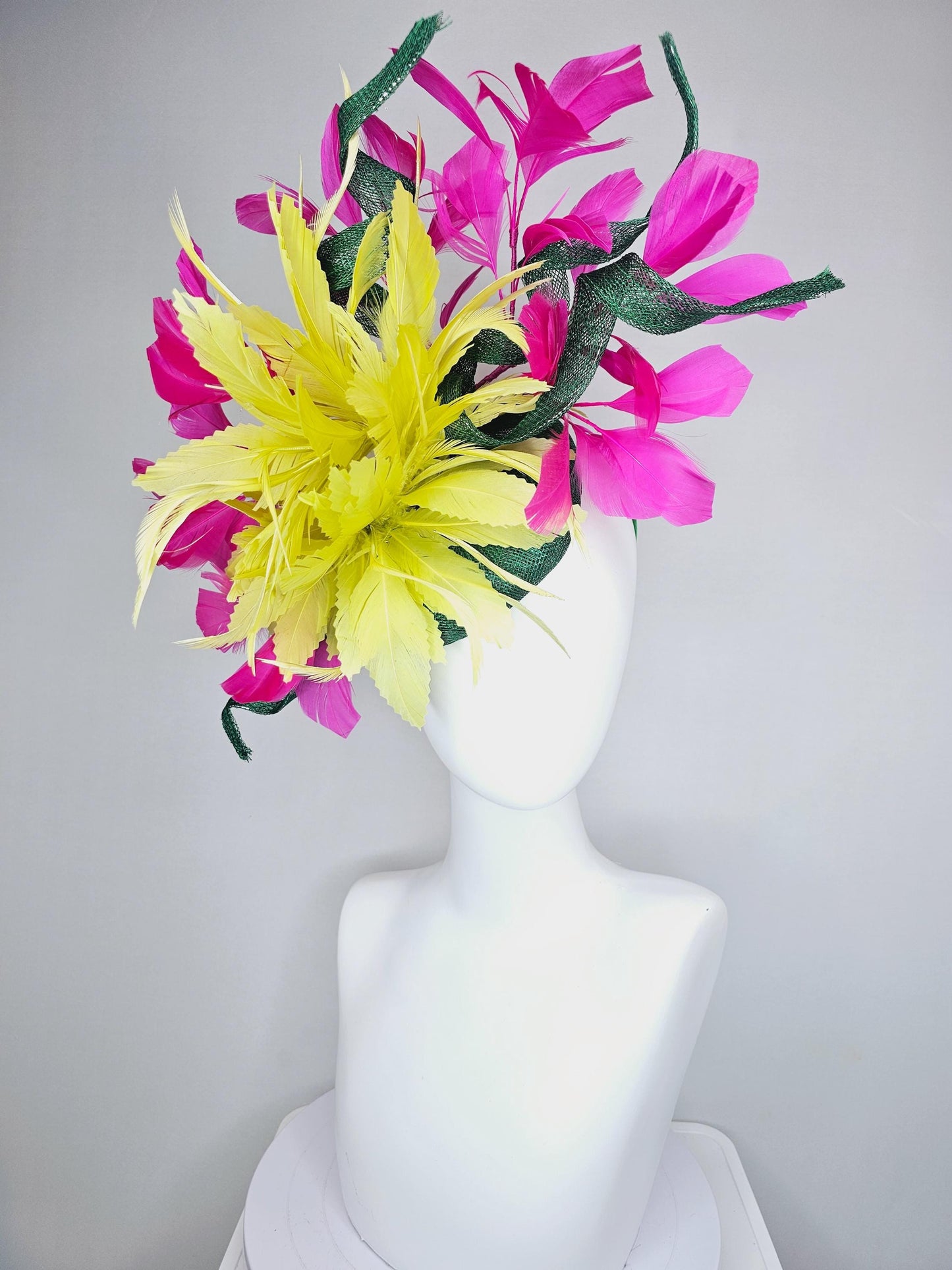 kentucky derby hat fascinator dark green sinamay with curls and fluffy yellow zigzag feather flower, bright pink fuchsia branching feathers