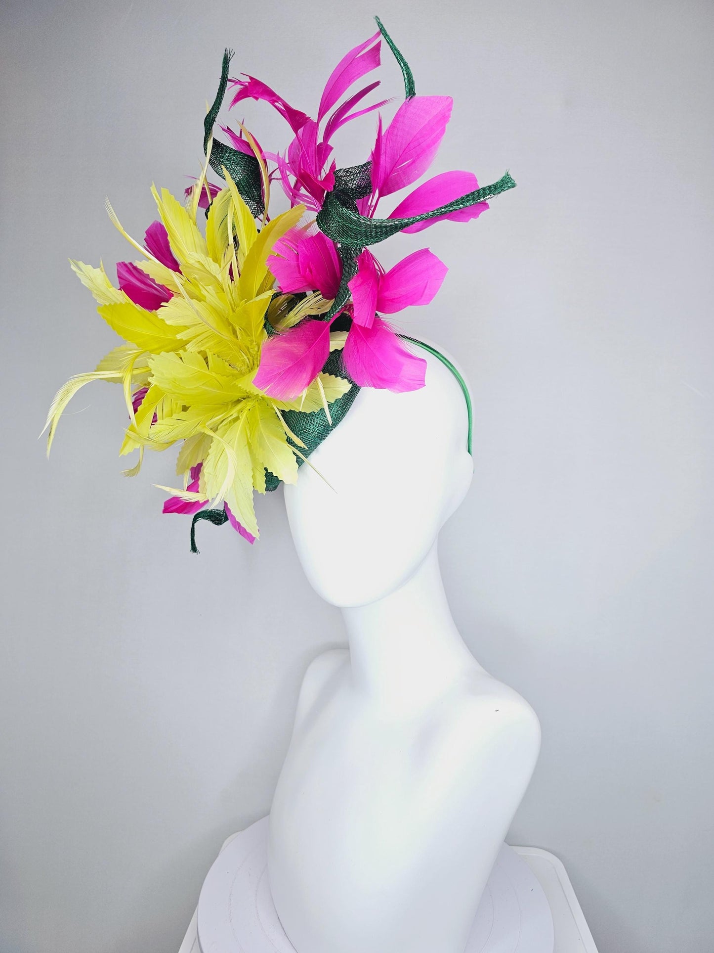 kentucky derby hat fascinator dark green sinamay with curls and fluffy yellow zigzag feather flower, bright pink fuchsia branching feathers