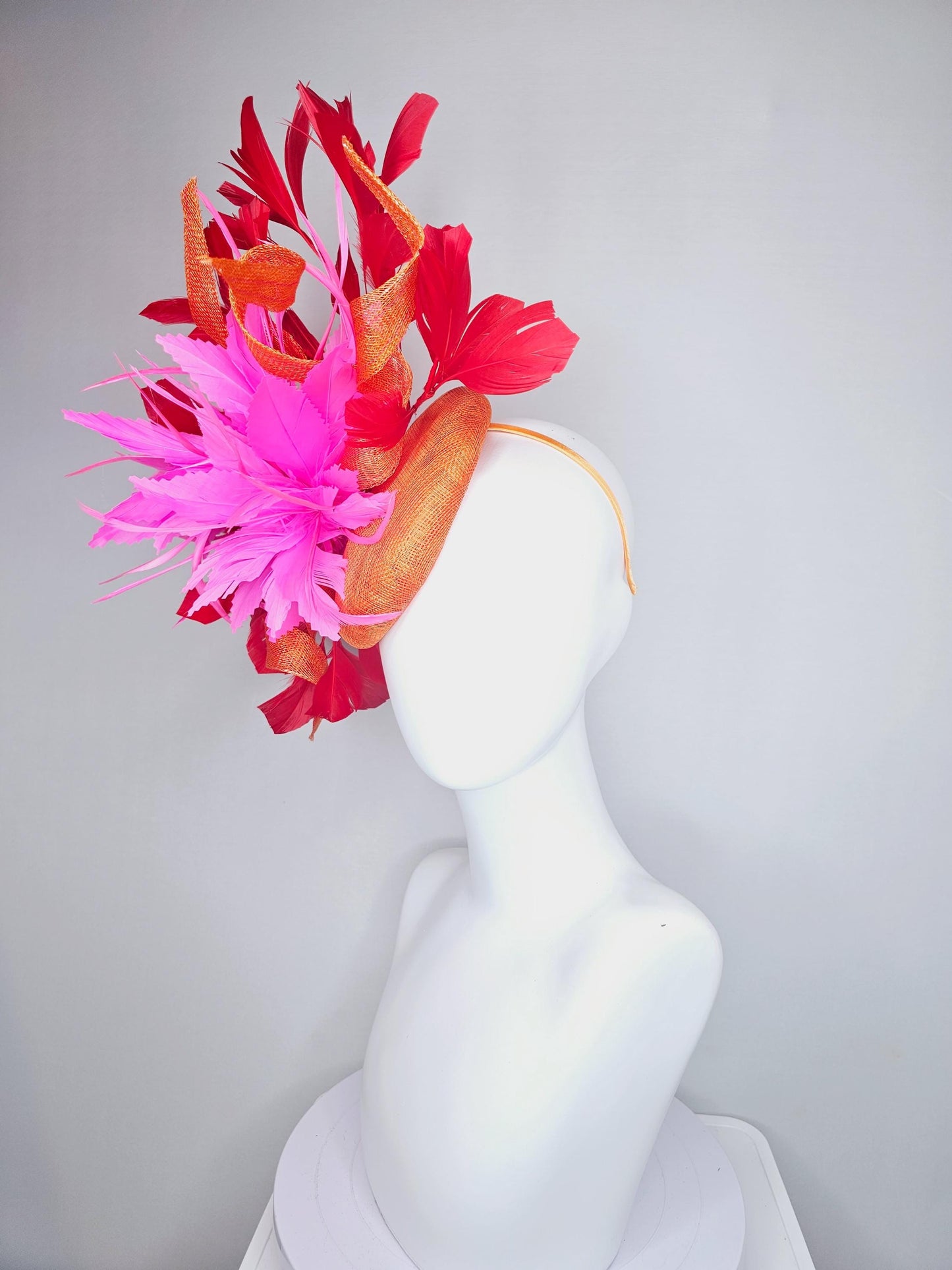 kentucky derby hat fascinator orange sinamay with curls and fluffy zigzag bright pink feather flower, red branching feathers