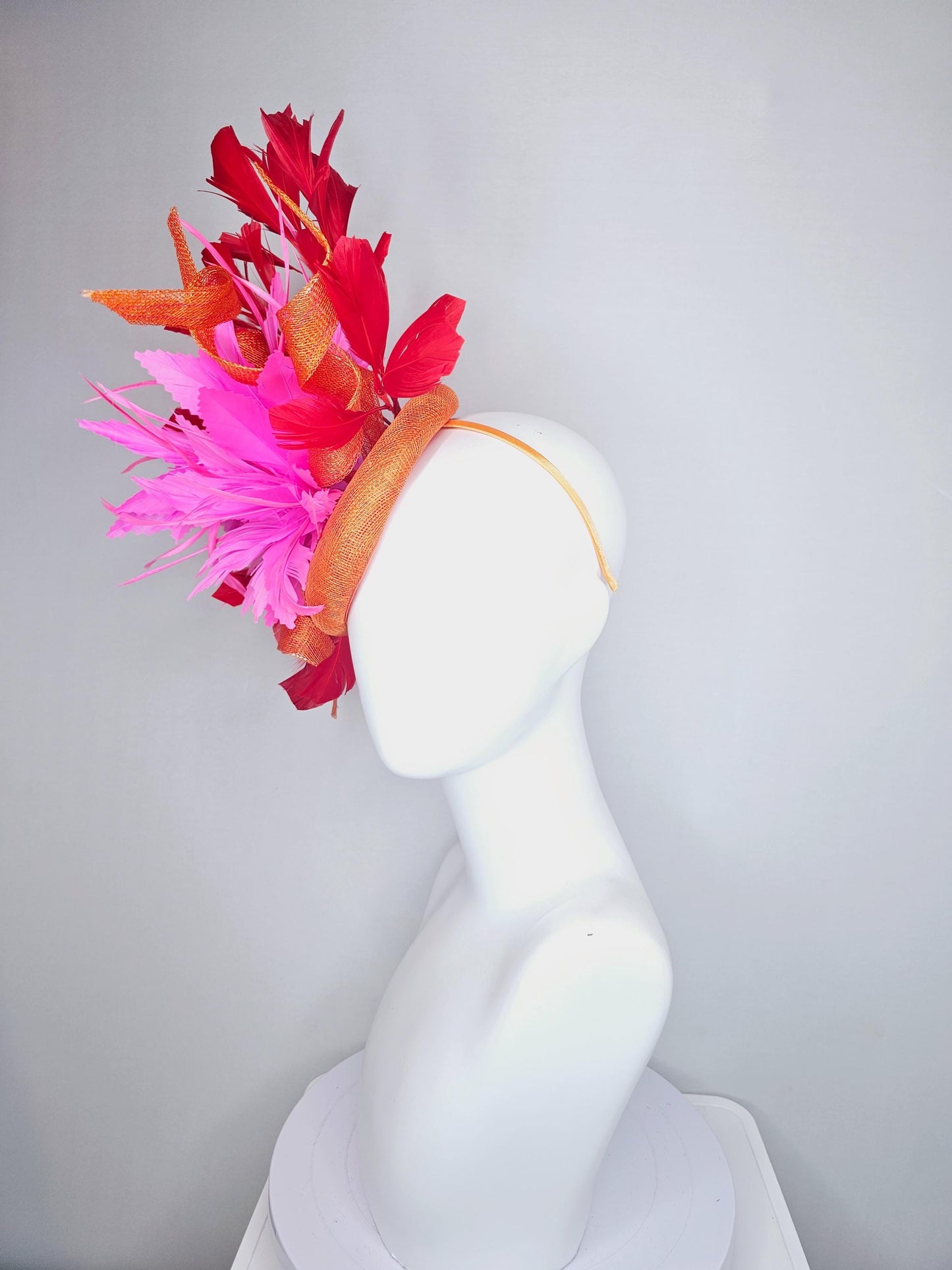 kentucky derby hat fascinator orange sinamay with curls and fluffy zigzag bright pink feather flower, red branching feathers