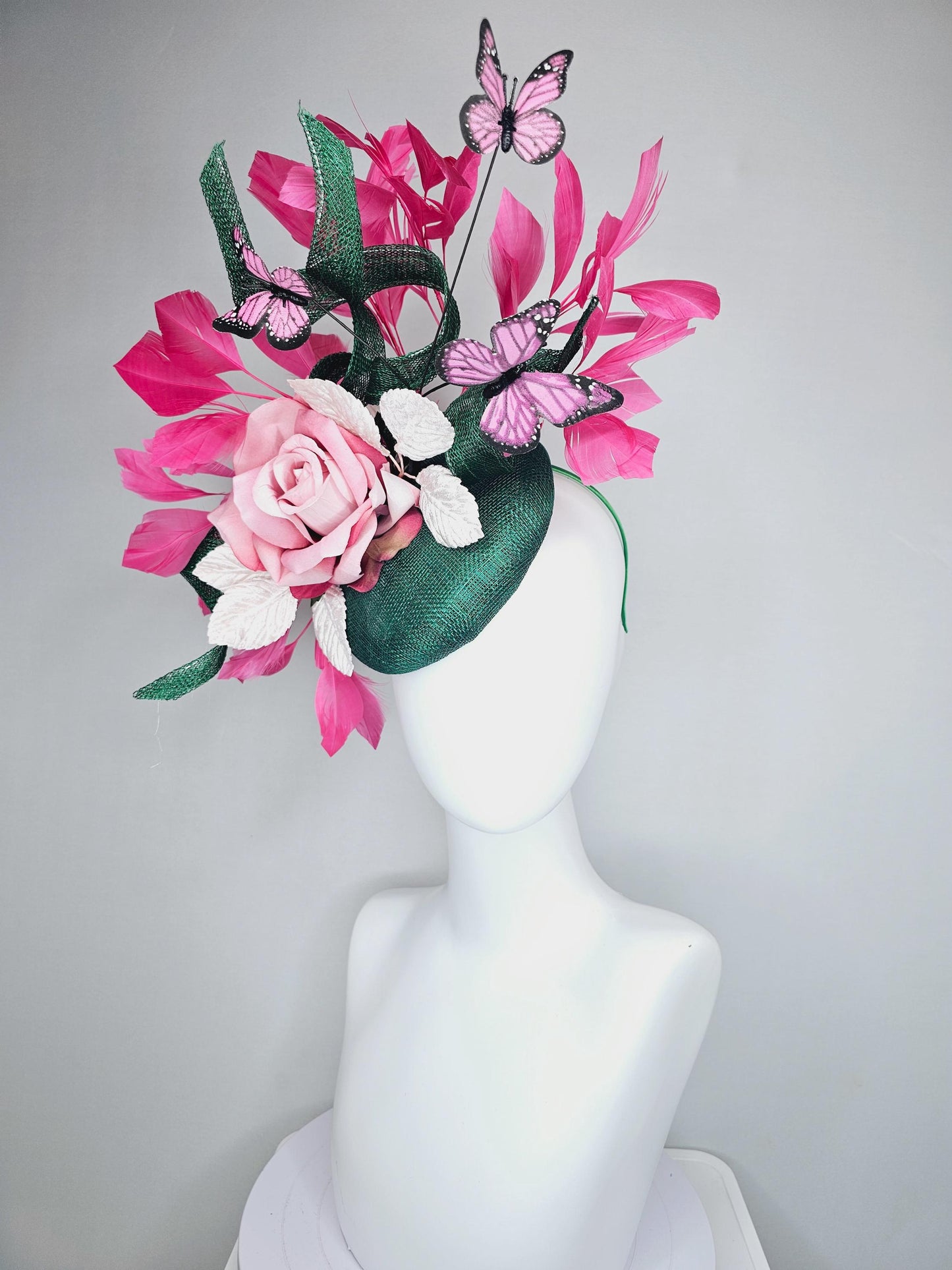 kentucky derby hat fascinator dark green sinamay w/ curls, pink ombre satin rose,white leaves,pink branching feathers,pink black butterflies