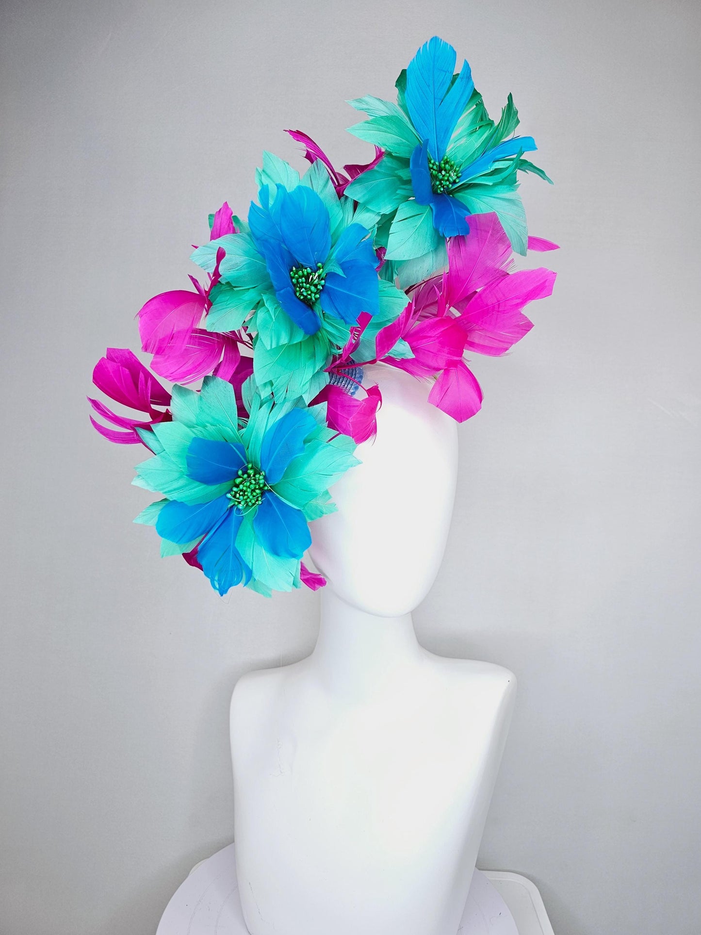 kentucky derby hat fascinator with large mint green sky blue feather flowers and bright fuchsia pink branching feathers