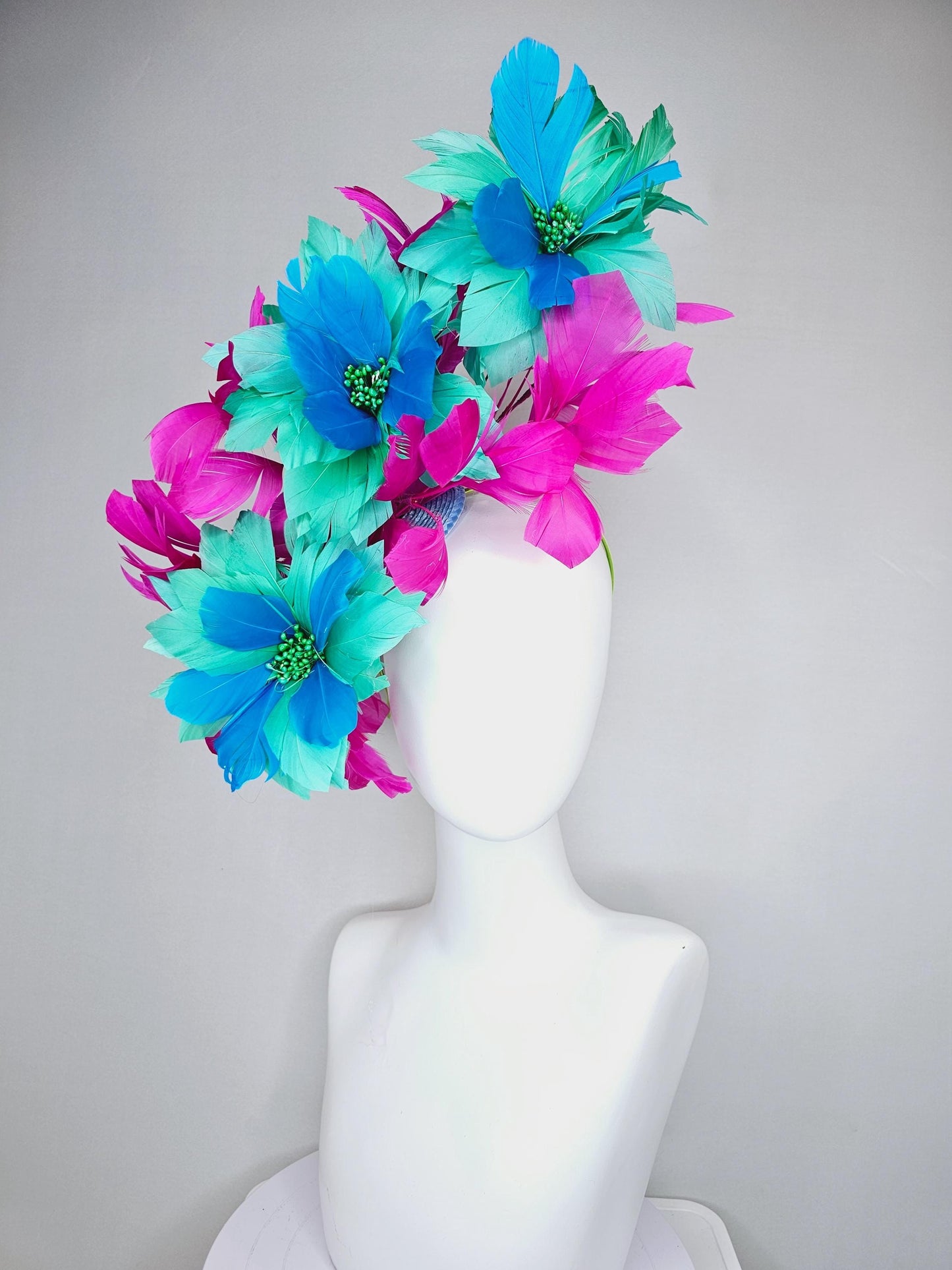 kentucky derby hat fascinator with large mint green sky blue feather flowers and bright fuchsia pink branching feathers