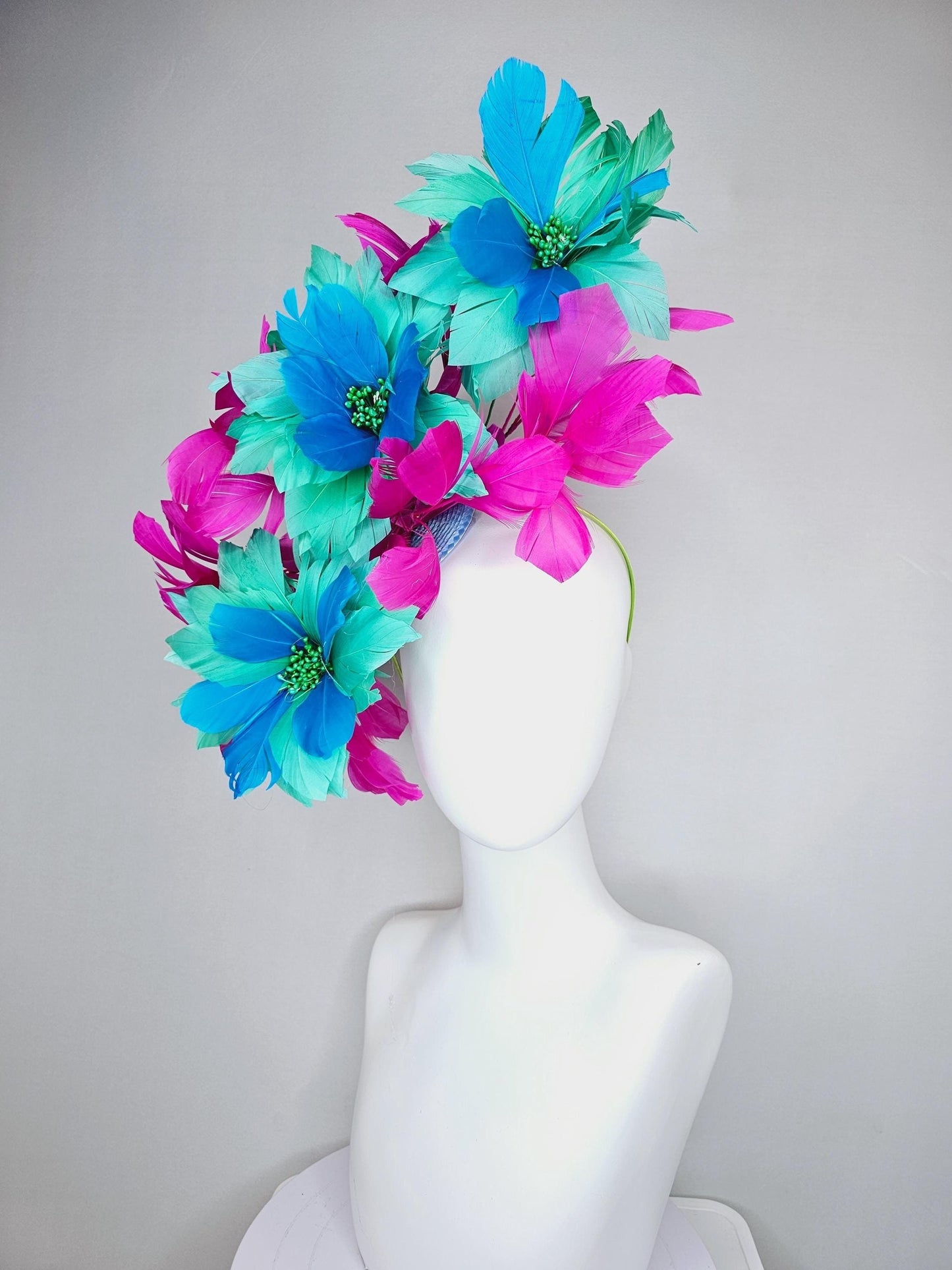 kentucky derby hat fascinator with large mint green sky blue feather flowers and bright fuchsia pink branching feathers