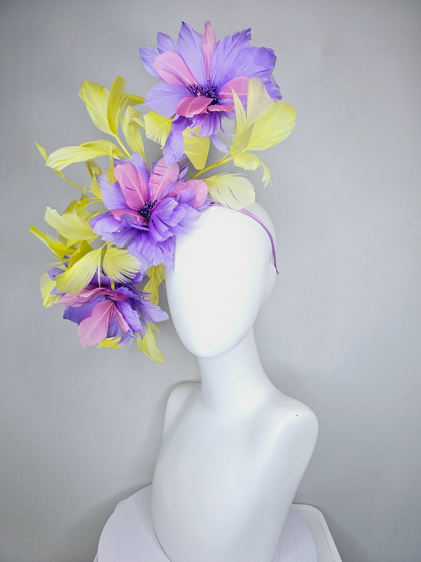 kentucky derby hat fascinator with large lavender purple light pink feather flowers and yellow branching feathers