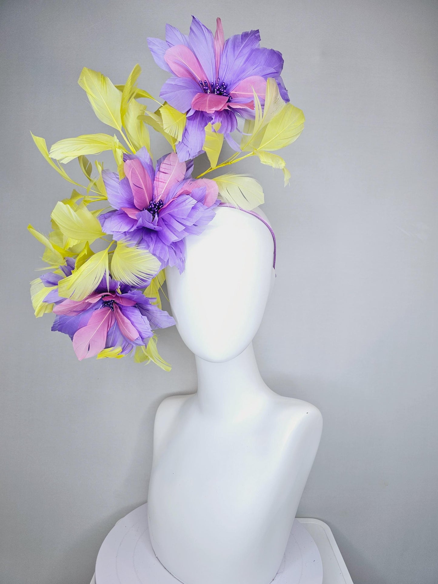 kentucky derby hat fascinator with large lavender purple light pink feather flowers and yellow branching feathers