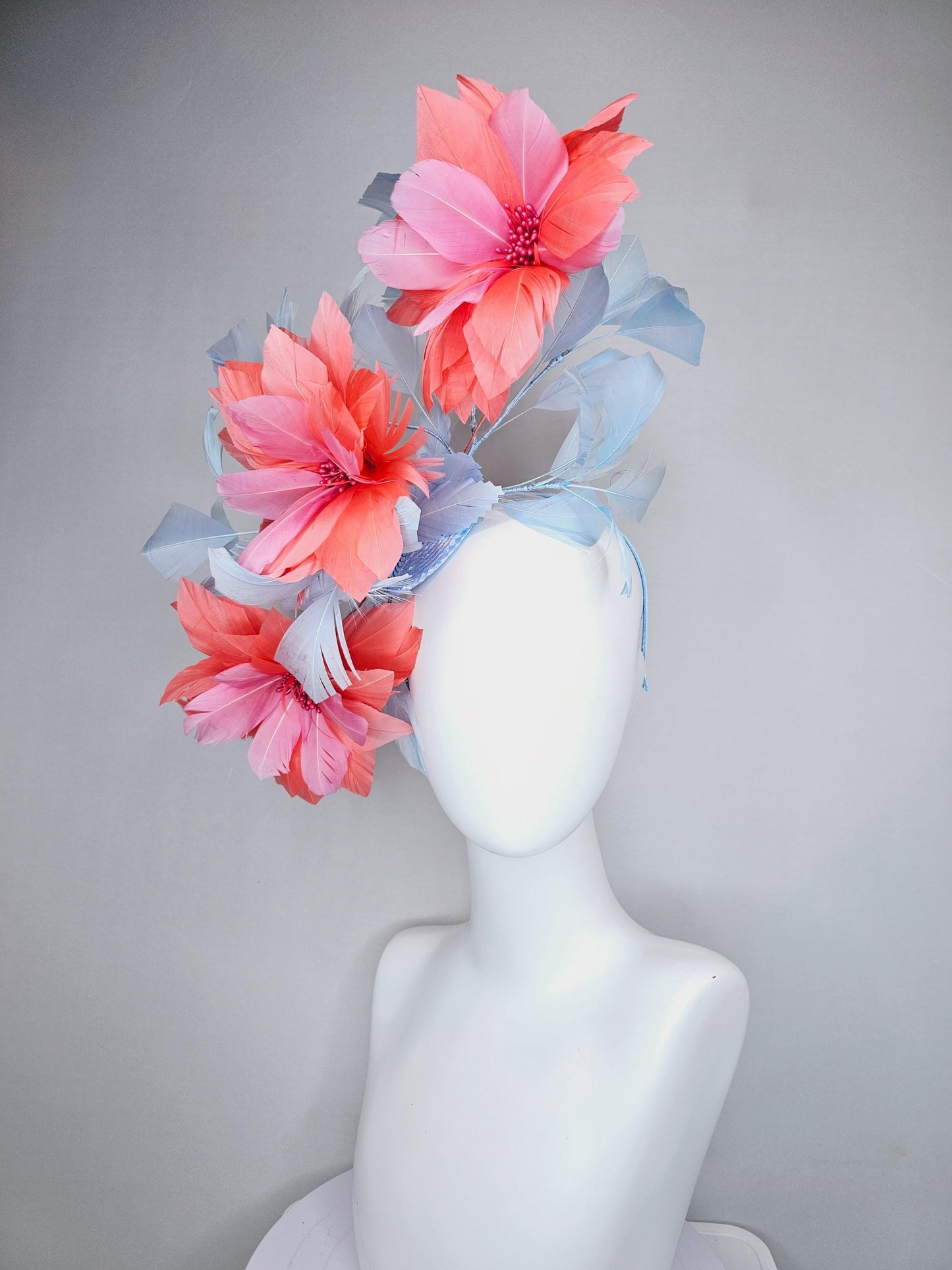 kentucky derby hat fascinator with large coral orange light pink feather flowers and light baby blue branching feathers