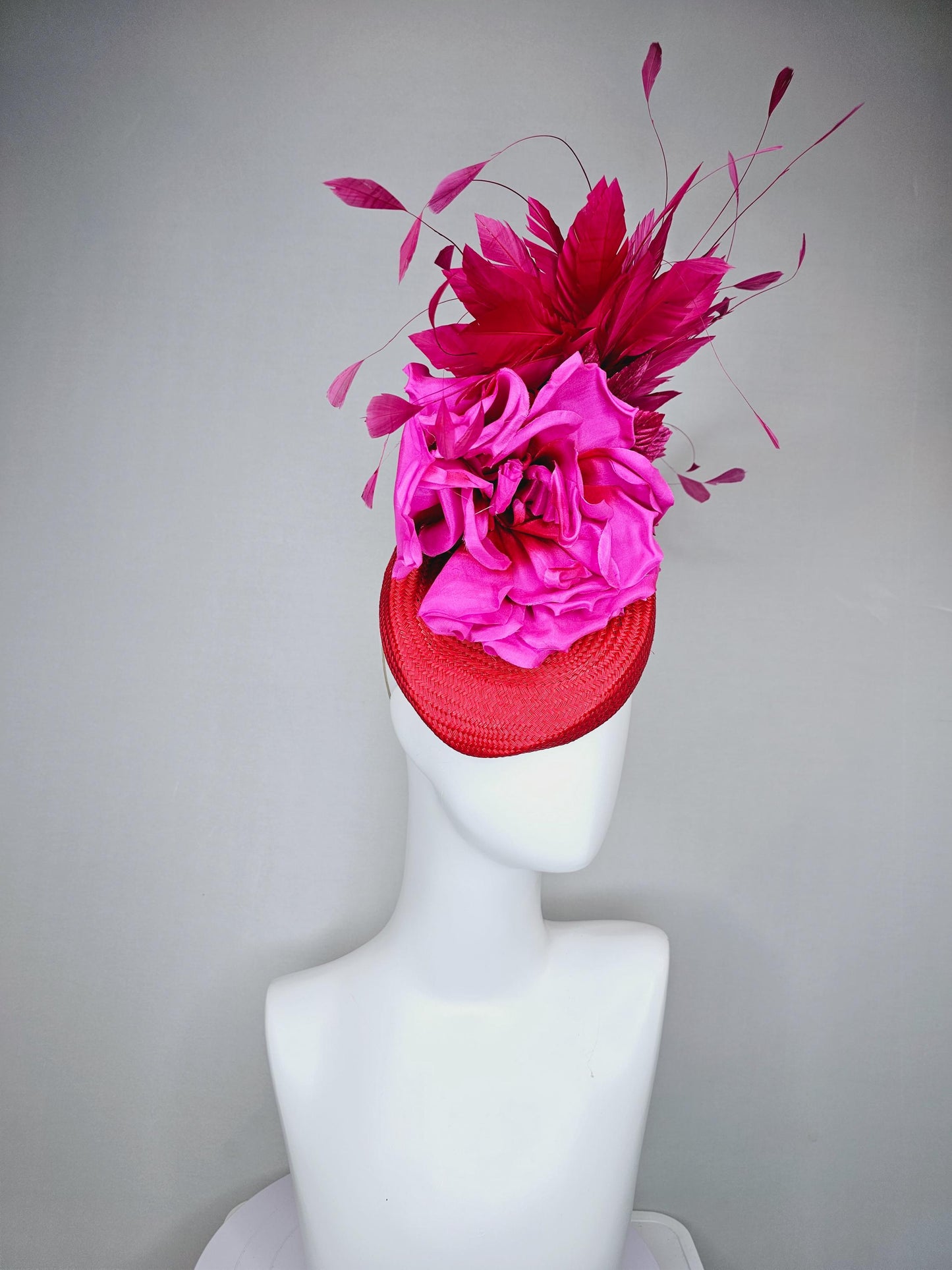 kentucky derby hat fascinator bright red woven base with large fuchsia pink satin silk rose flower and hot pink branching feathers