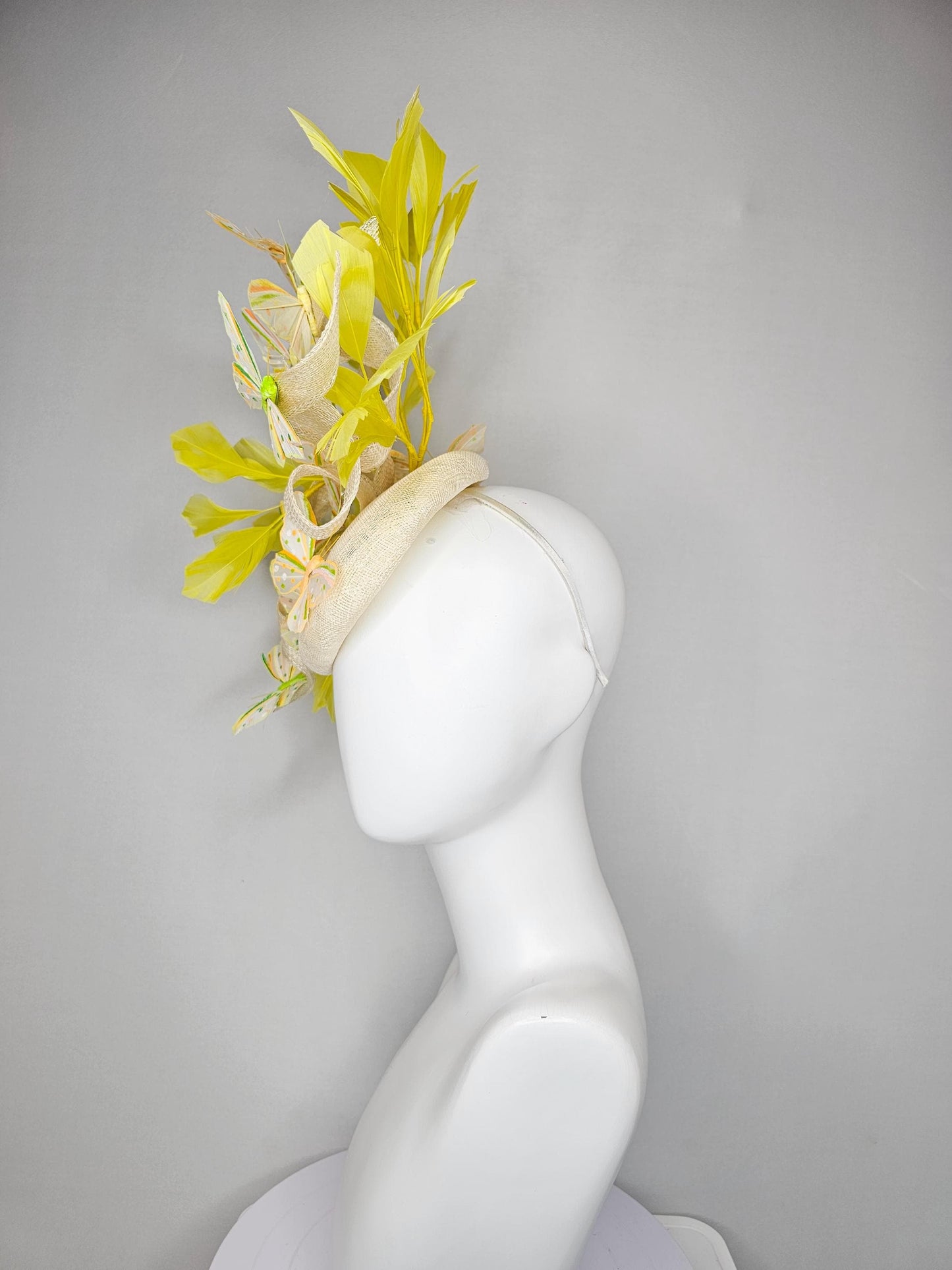 kentucky derby hat fascinator white sinamay with large curls,yellow branching feathers and green,yellow,orange dotted feather butterflies