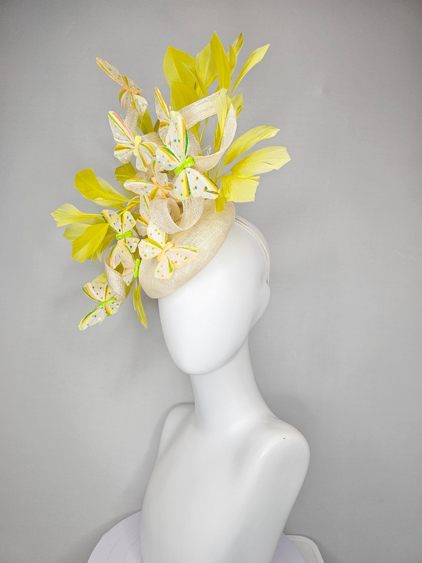 kentucky derby hat fascinator white sinamay with large curls,yellow branching feathers and green,yellow,orange dotted feather butterflies