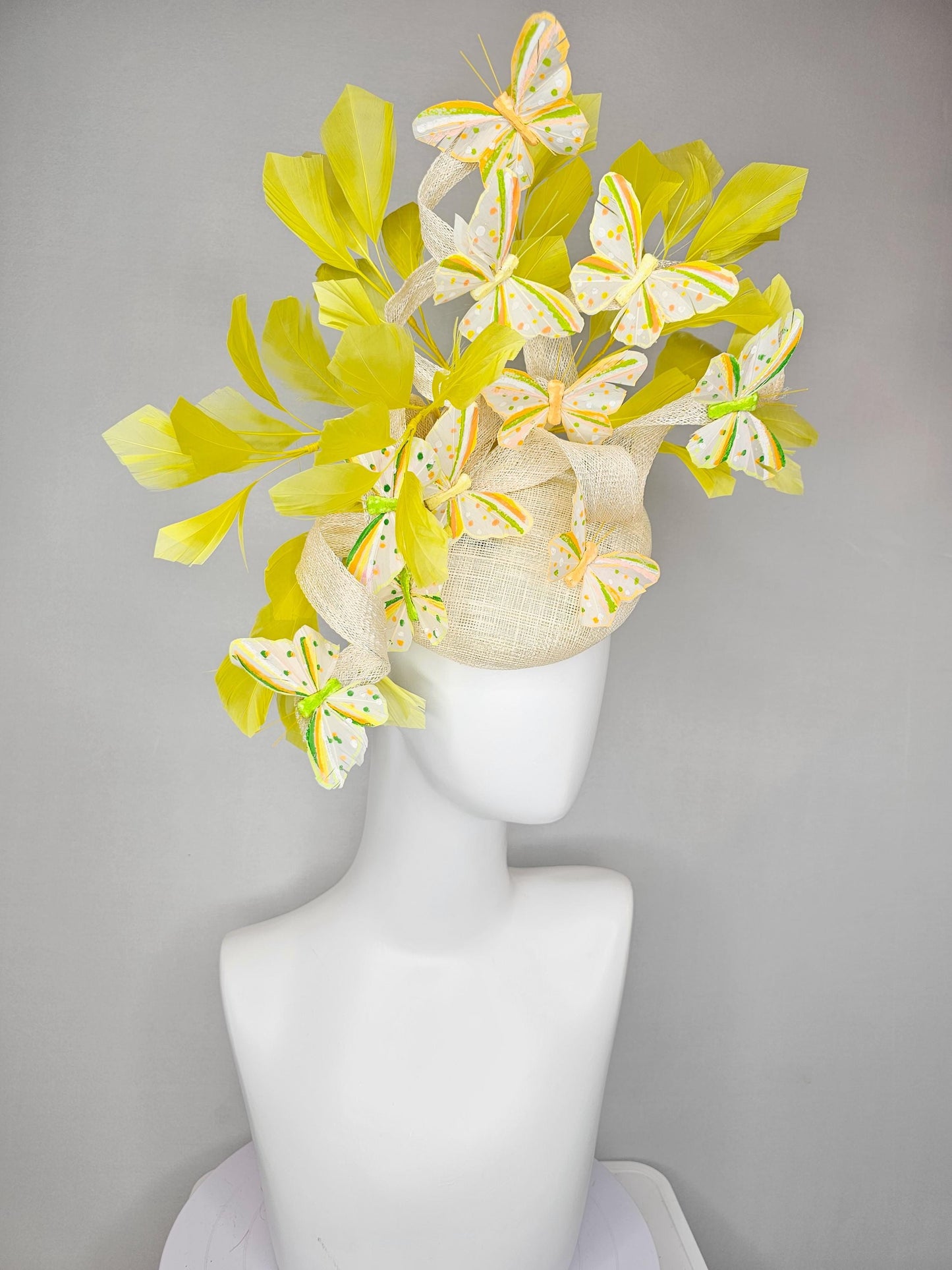 kentucky derby hat fascinator white sinamay with large curls,yellow branching feathers and green,yellow,orange dotted feather butterflies