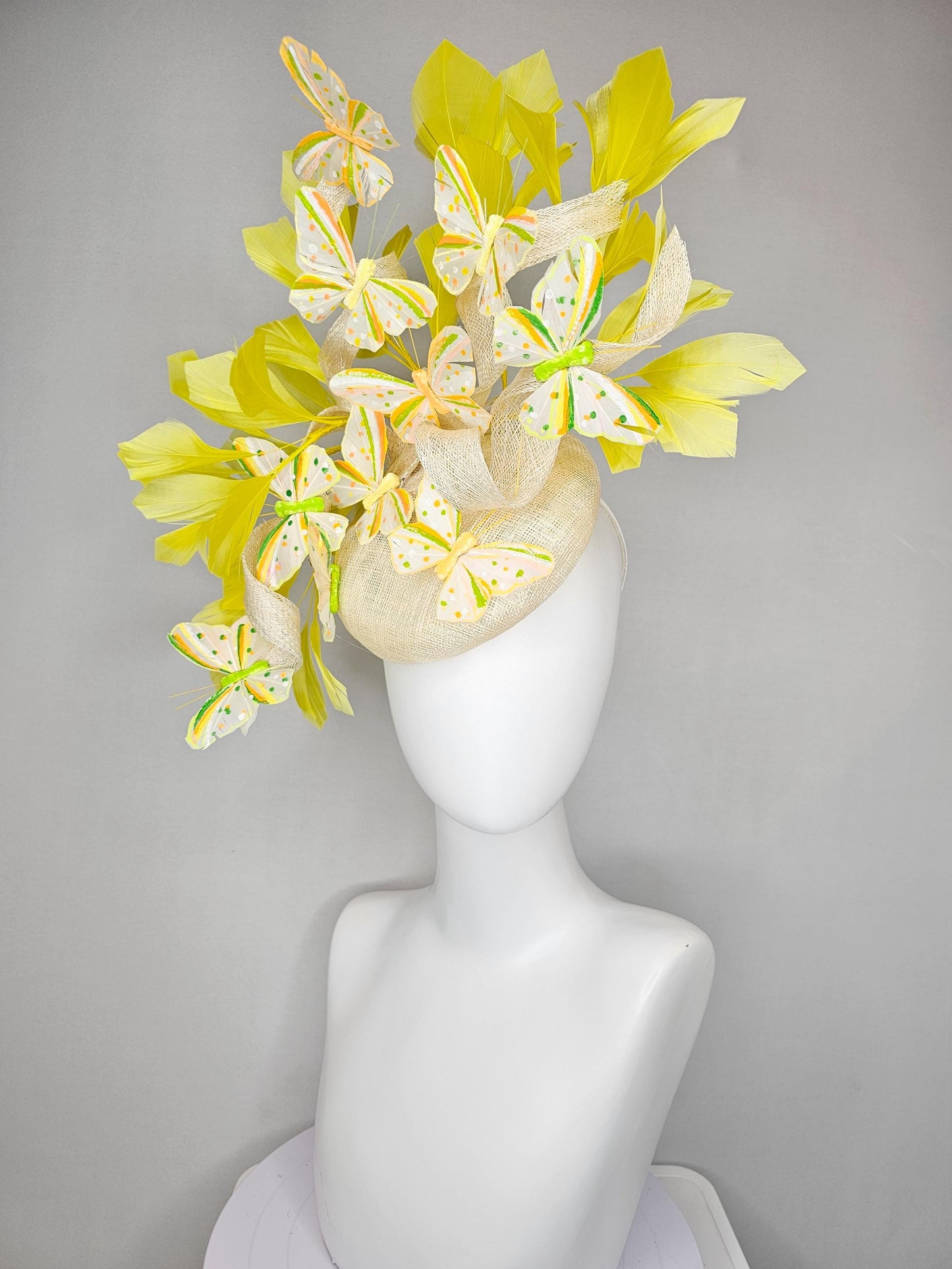 kentucky derby hat fascinator white sinamay with large curls,yellow branching feathers and green,yellow,orange dotted feather butterflies