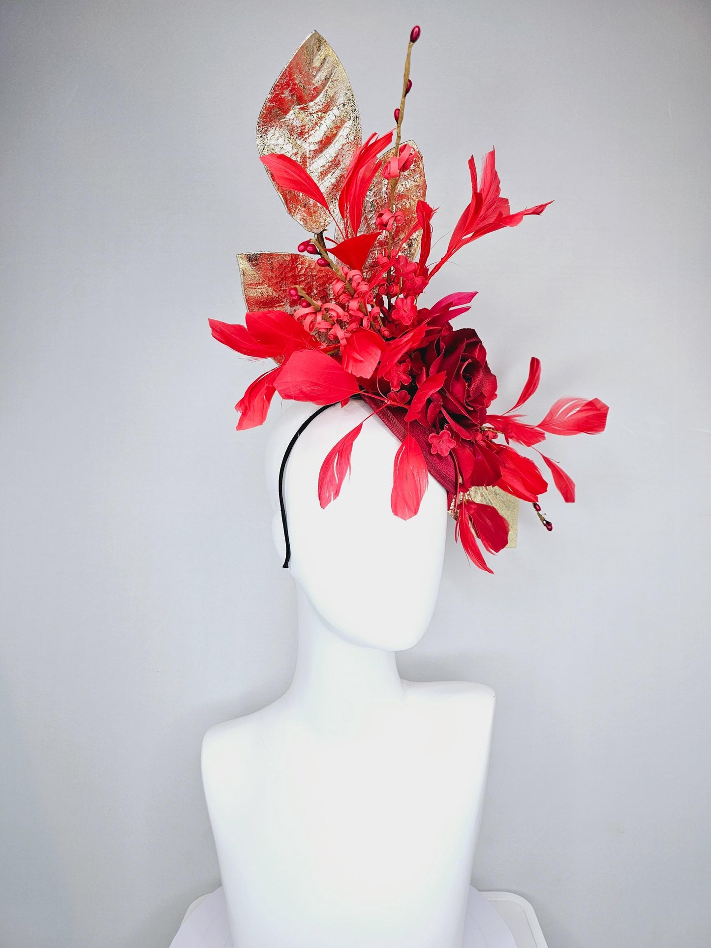 kentucky derby hat fascinator burgundy red satin with burgundy red satin rose flower, cherry red branching feathers, gold leaves and stems