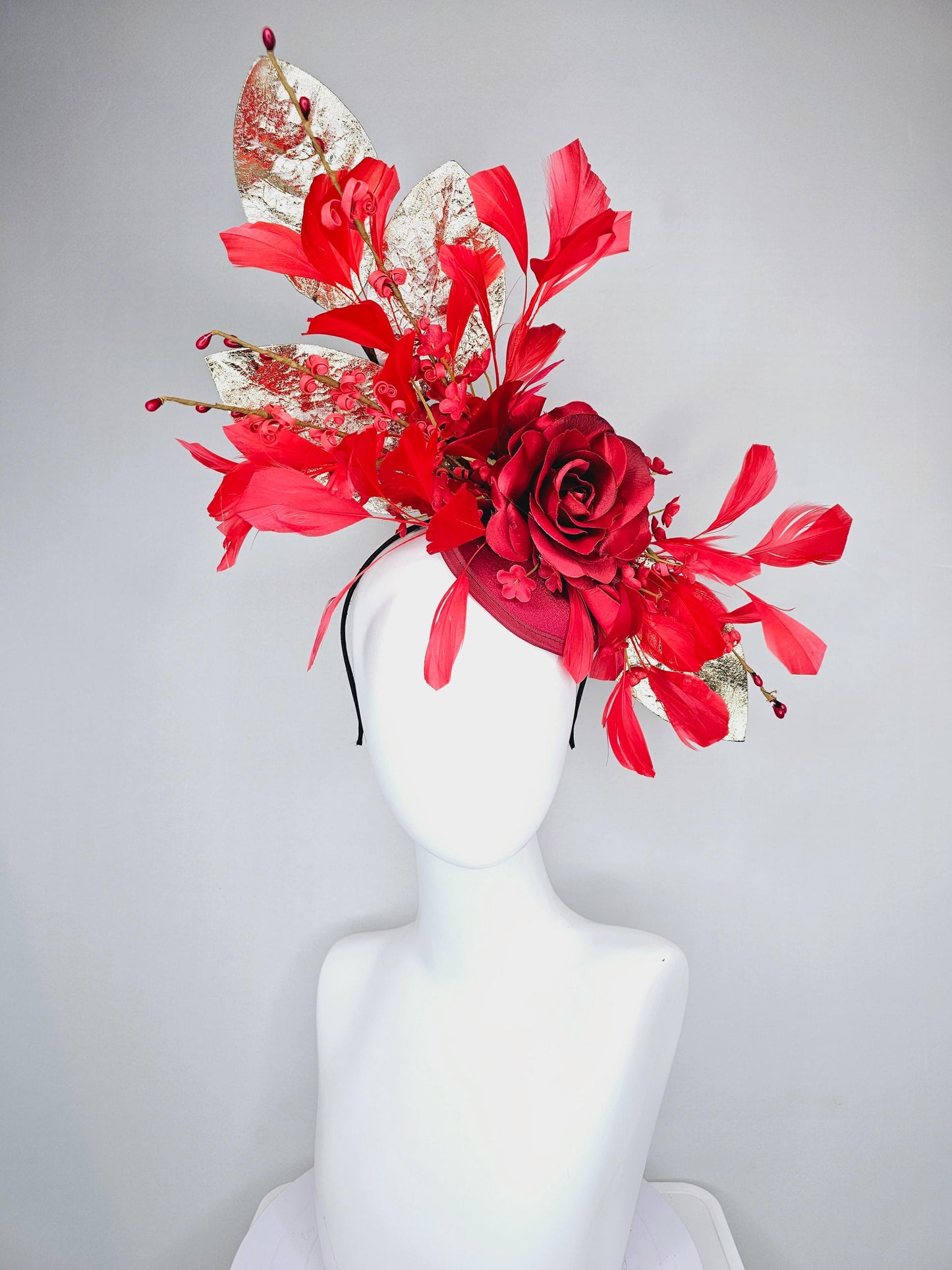 kentucky derby hat fascinator burgundy red satin with burgundy red satin rose flower, cherry red branching feathers, gold leaves and stems