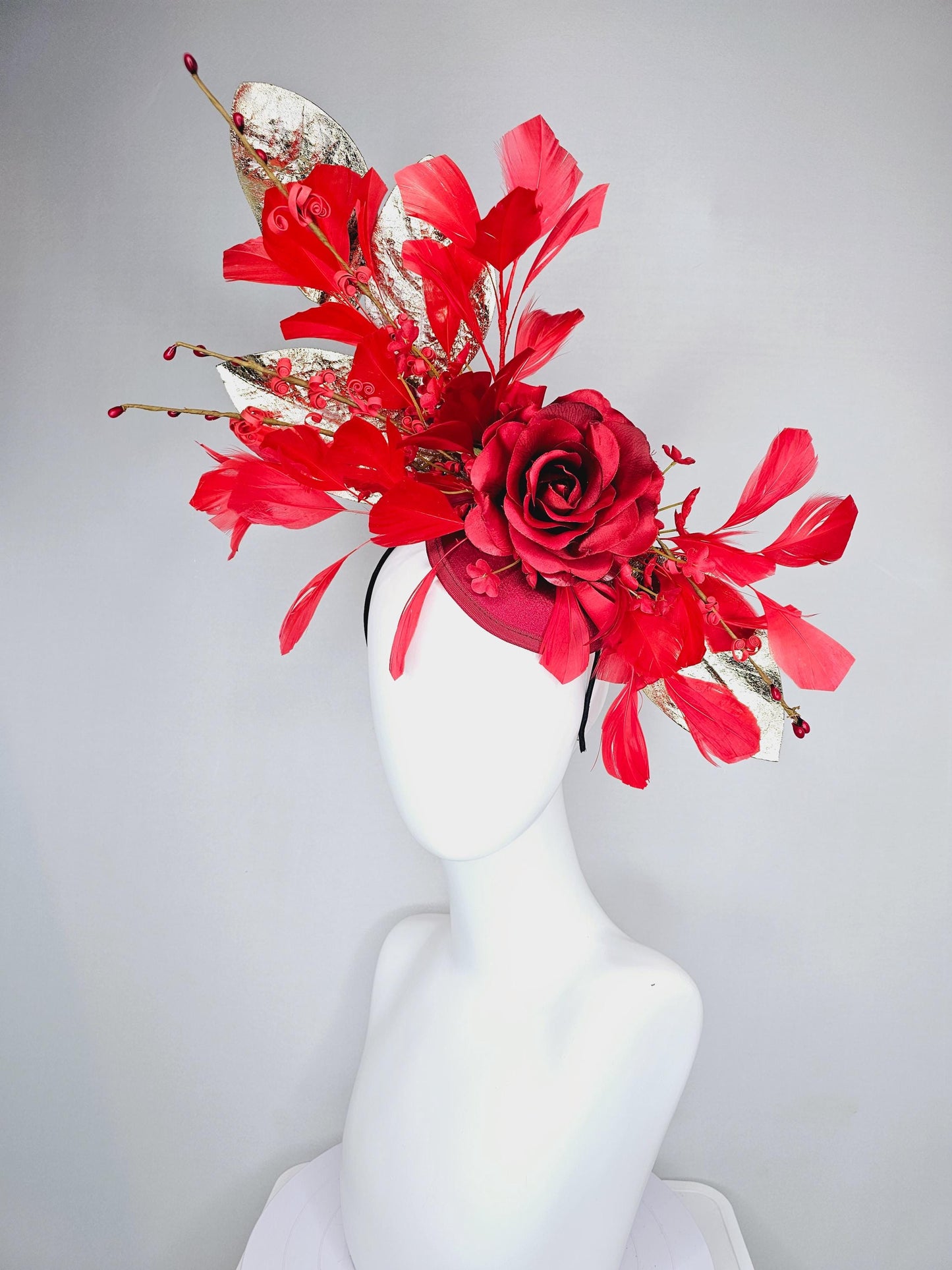 kentucky derby hat fascinator burgundy red satin with burgundy red satin rose flower, cherry red branching feathers, gold leaves and stems