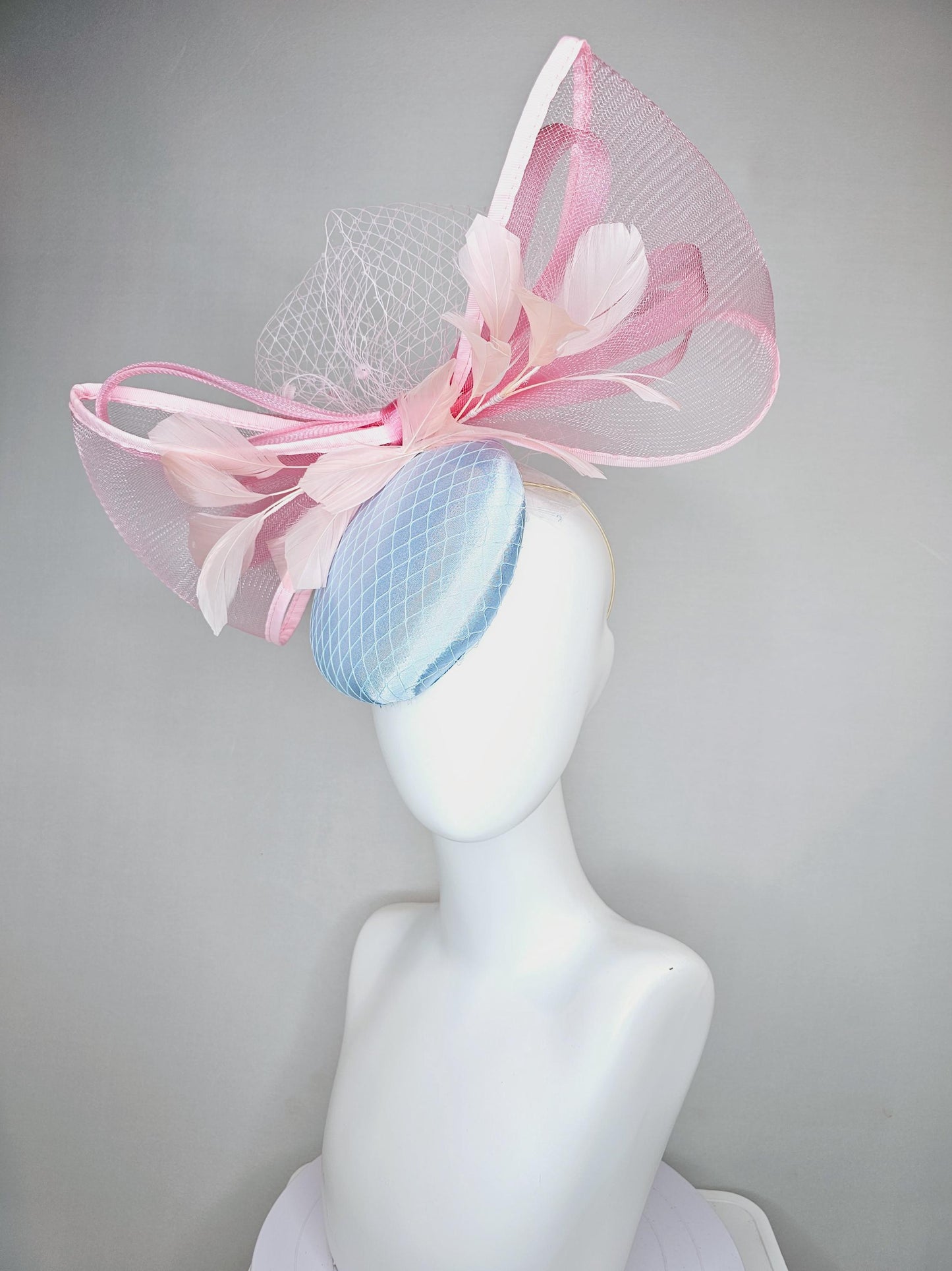 kentucky derby hat fascinator light baby blue satin with netting, branching light blush pink feathers and large mesh blush pink bow