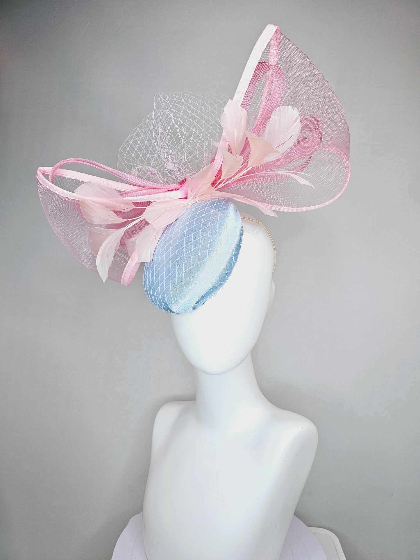 kentucky derby hat fascinator light baby blue satin with netting, branching light blush pink feathers and large mesh blush pink bow