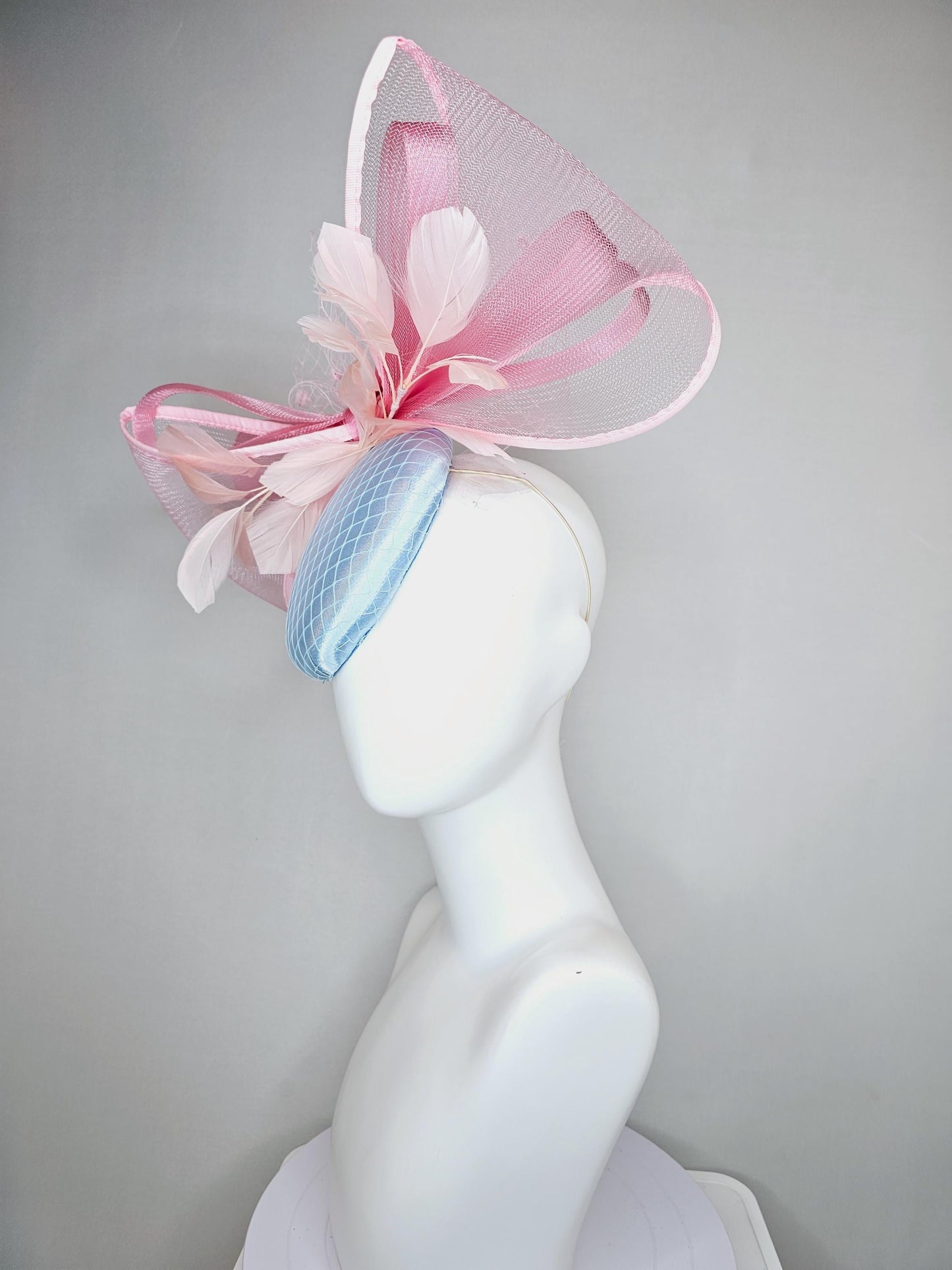 kentucky derby hat fascinator light baby blue satin with netting, branching light blush pink feathers and large mesh blush pink bow