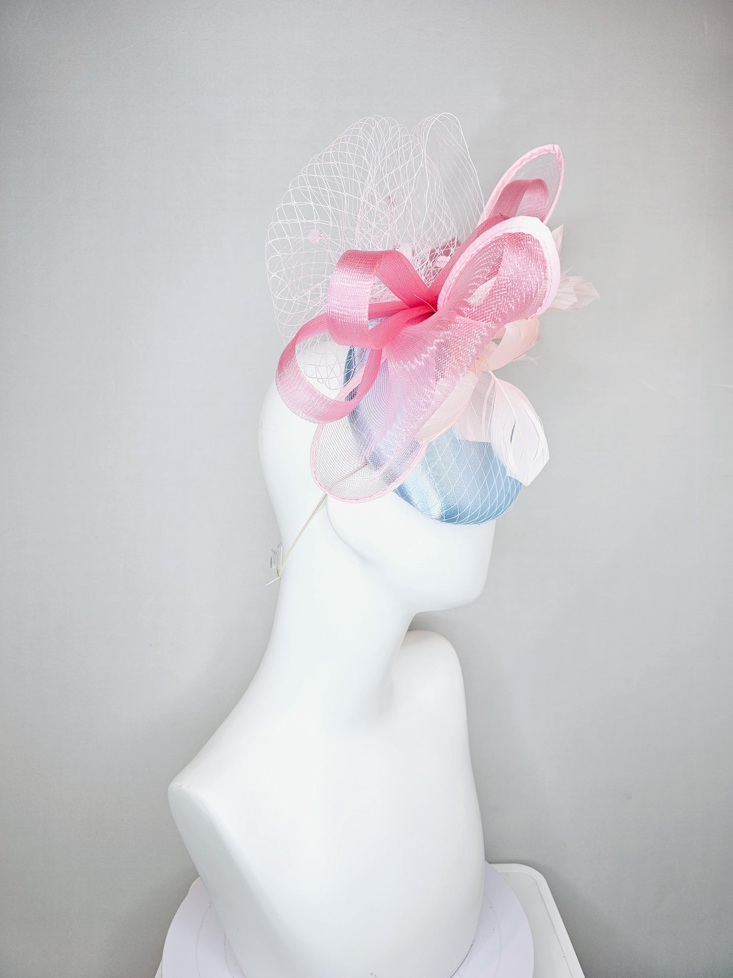 kentucky derby hat fascinator light baby blue satin with netting, branching light blush pink feathers and large mesh blush pink bow