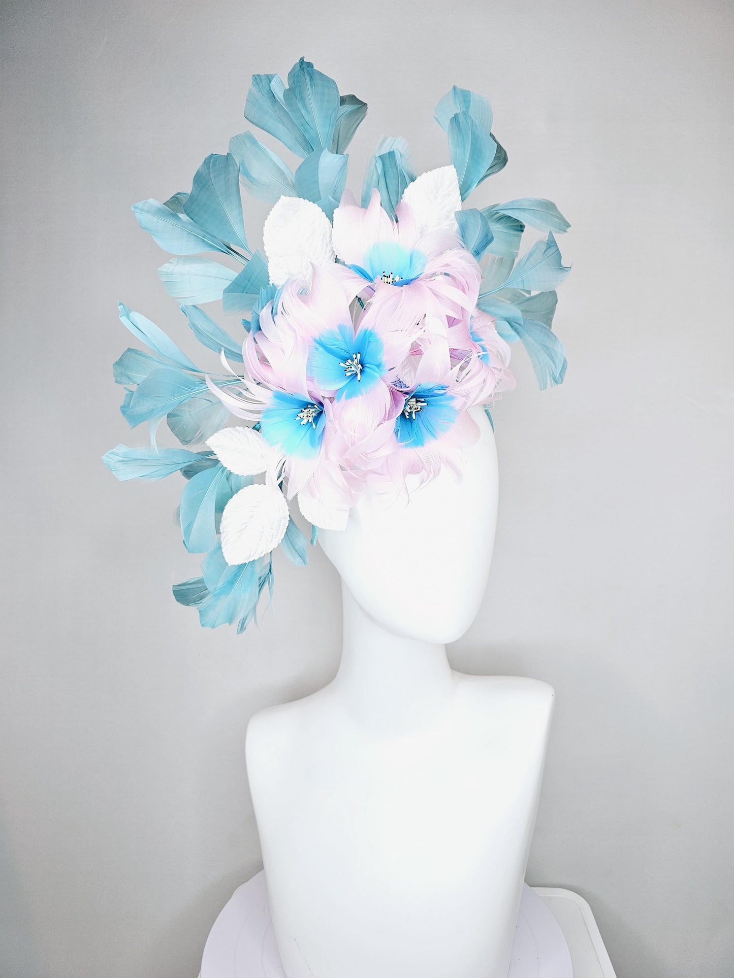 kentucky derby hat fascinator with pale pink feather flowers with sky blue feather cores, white leaves and teal blue branching feathers