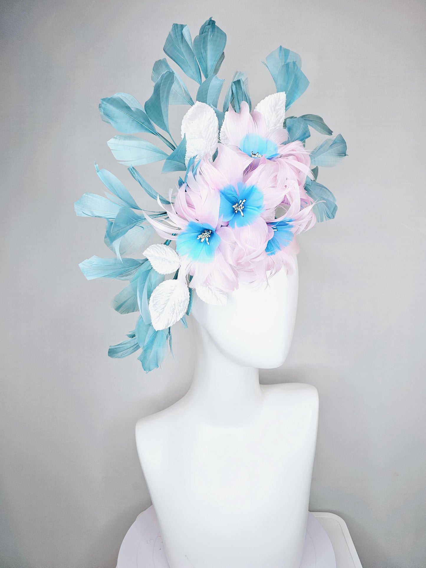 kentucky derby hat fascinator with pale pink feather flowers with sky blue feather cores, white leaves and teal blue branching feathers