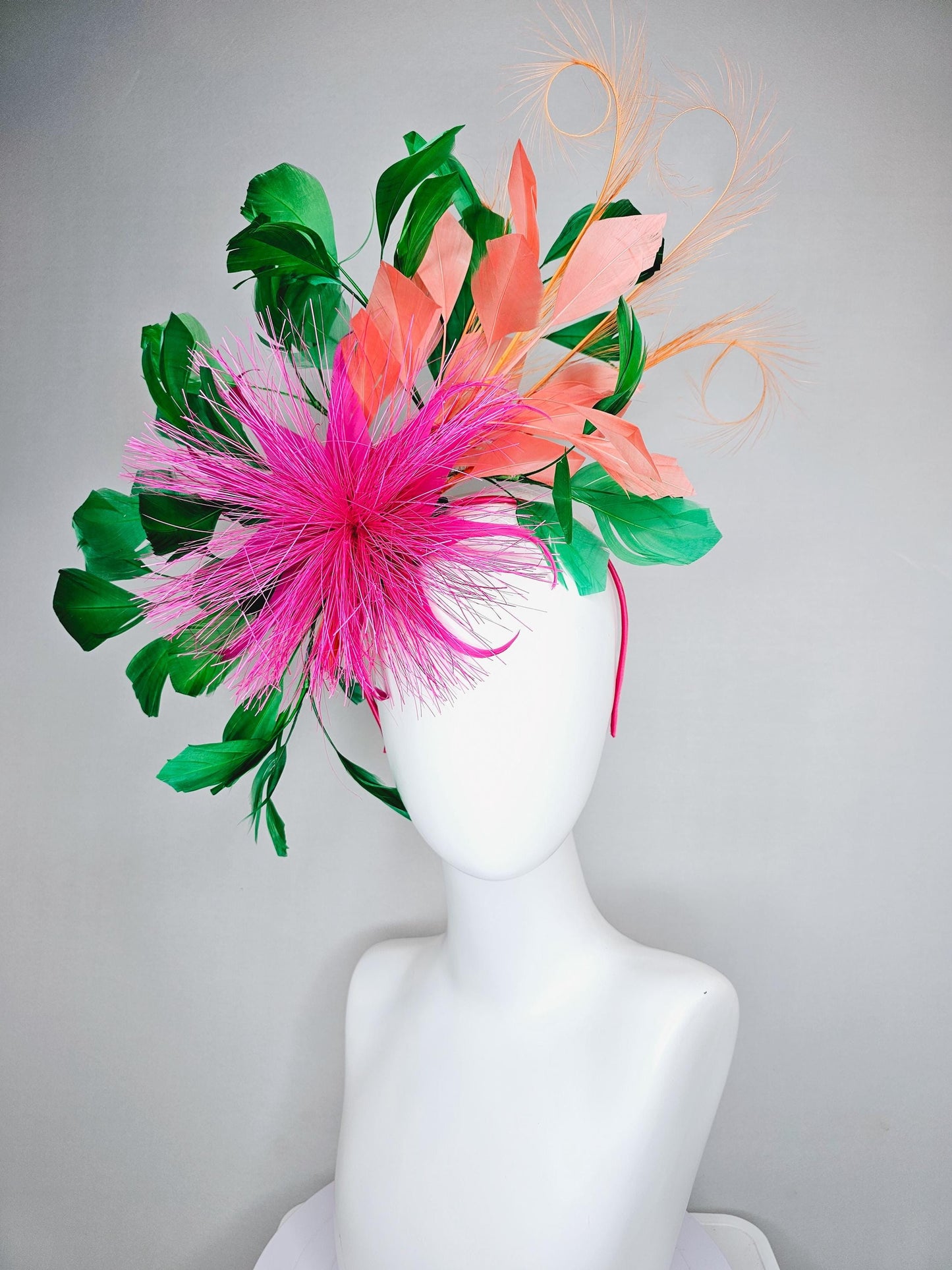 kentucky derby hat fascinator pink spiky feather flower, light orange peach, emerald green branching feathers and light peach feather curls