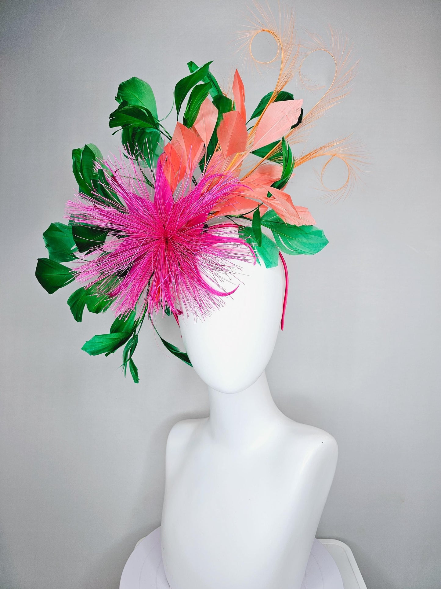 kentucky derby hat fascinator pink spiky feather flower, light orange peach, emerald green branching feathers and light peach feather curls