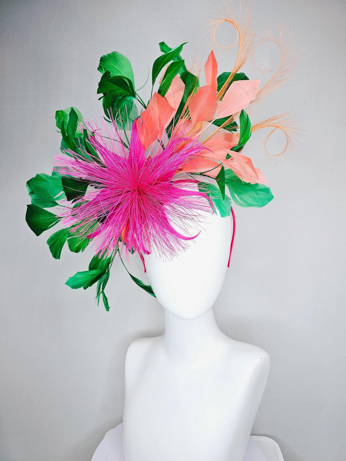 kentucky derby hat fascinator pink spiky feather flower, light orange peach, emerald green branching feathers and light peach feather curls