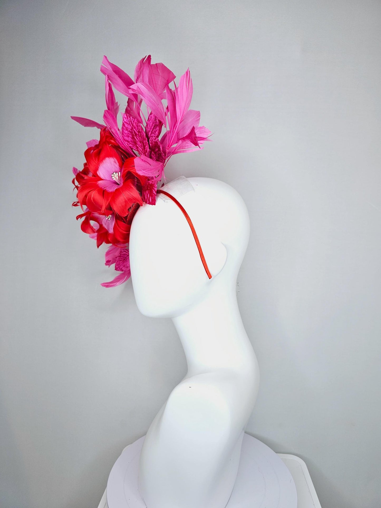 kentucky derby hat fascinator with cherry red feather flowers with blush pink feather cores, pink leaves and pink branching feathers